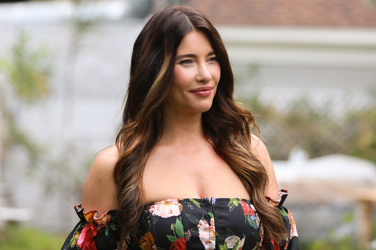 'The Bold and the Beautiful' actor Jacqueline MacInnes Wood wears a black floral blouse and black pants during a Hallmark Channel interview.