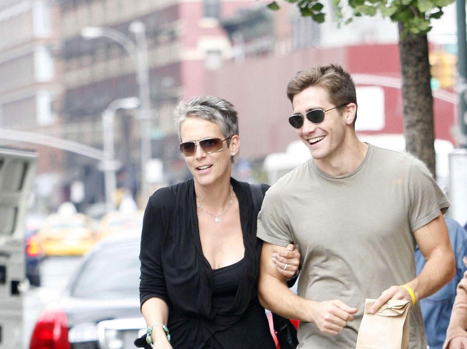 'Halloween' franchise star Jamie Lee Curtis and actor Jake Gyllenhaal walk together wearing sunglasses.