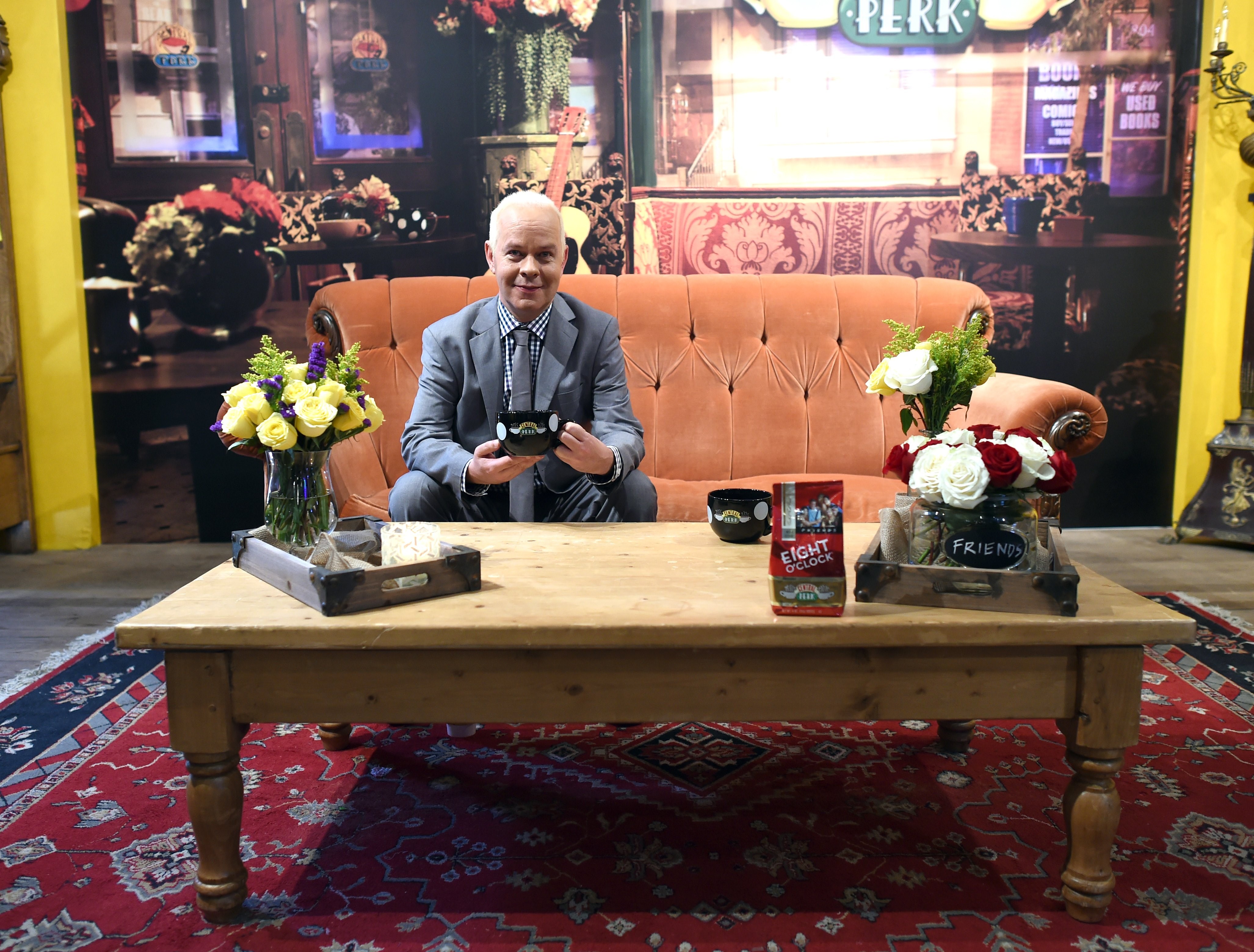 James Michael Tyler sits on the iconic Central Perk couch at a pop up event. Tyler played Gunther on 'Friends'