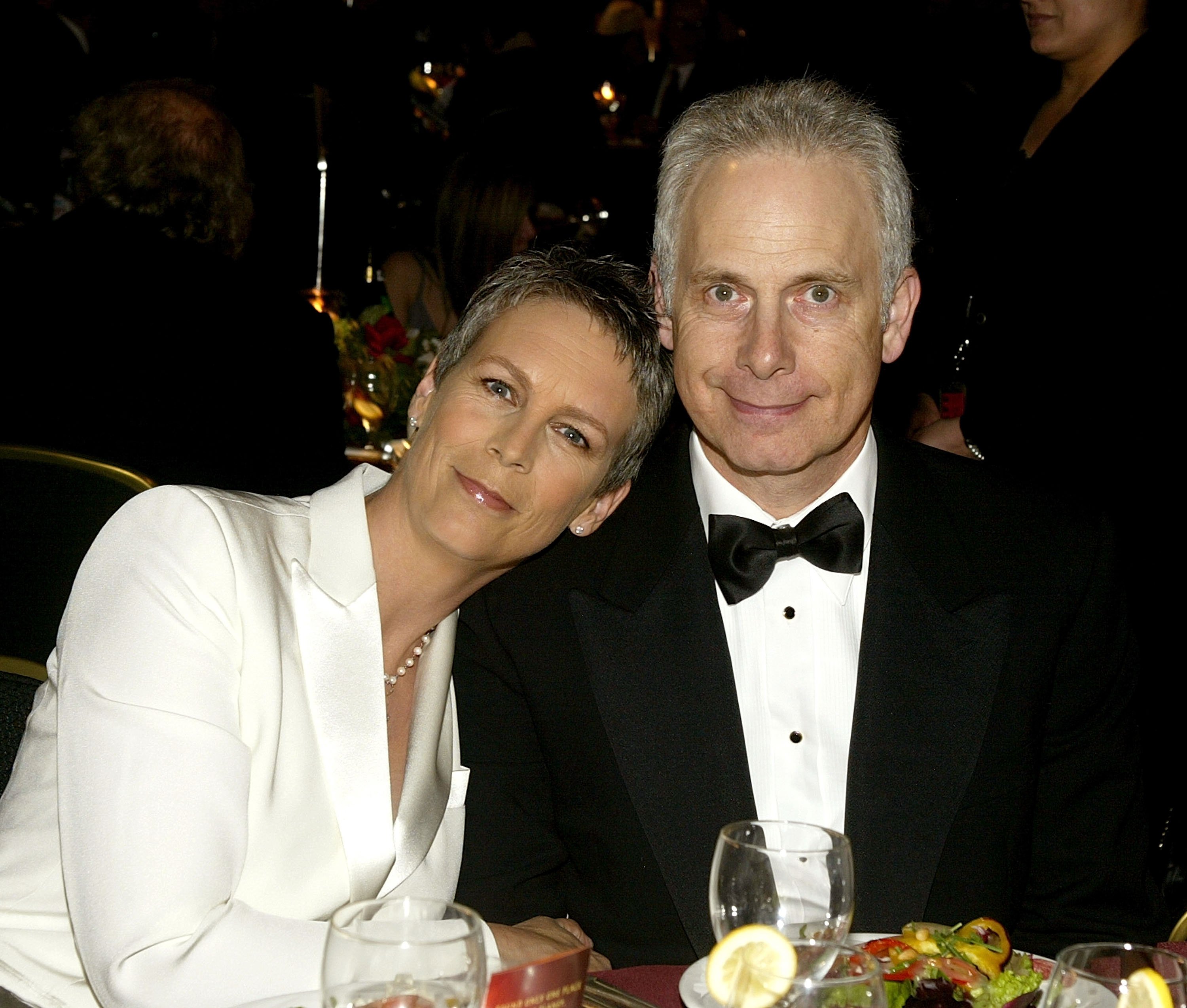 Jamie Lee Curtis leans her head on Christopher Guest's shoulder.