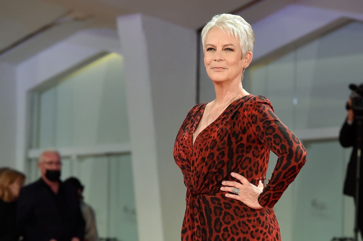 Jamie Lee Curtis hand on hip in red dress