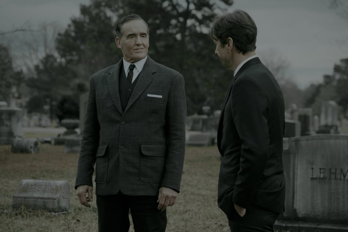 'Stargirl' Season 2 Episode 9 actors John Wesley Shipp as Jay Garrick/The Flash  and Luke Wilson as Pat Dugan dress in suits and stand in a cemetery.