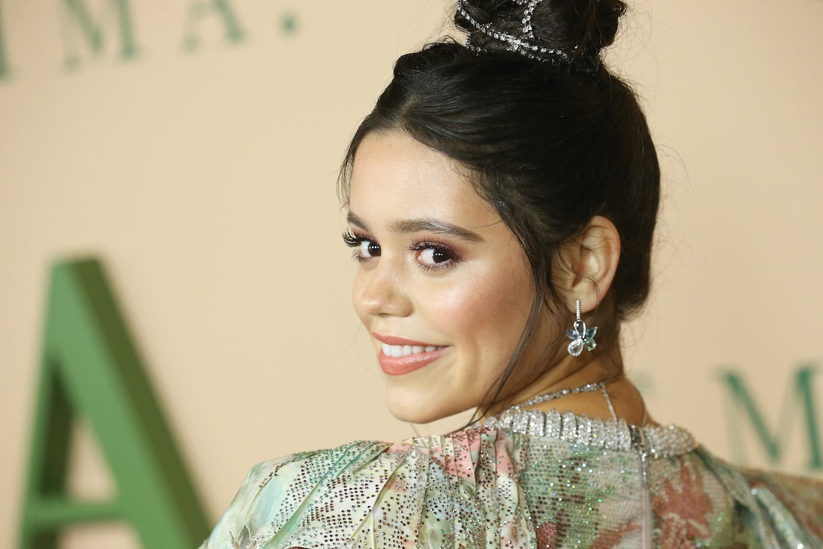 Wednesday Addams actor Jenna Ortega smiles at the camera over her shoulder