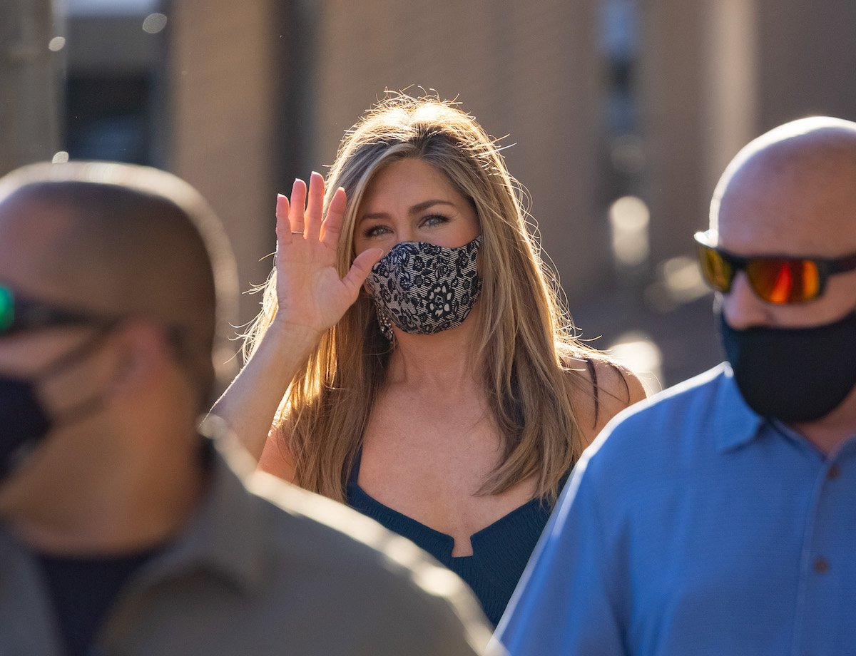 Jennifer Aniston waves to paparazzi