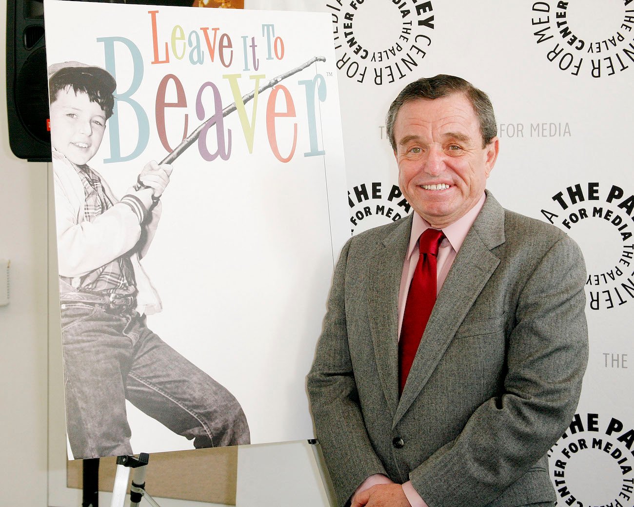 Jerry Mathers smiles as he stands next to a photo of himself as Theodore "Beaver" Cleaver at PaleyFest: Rewind 'Leave It to Beaver'