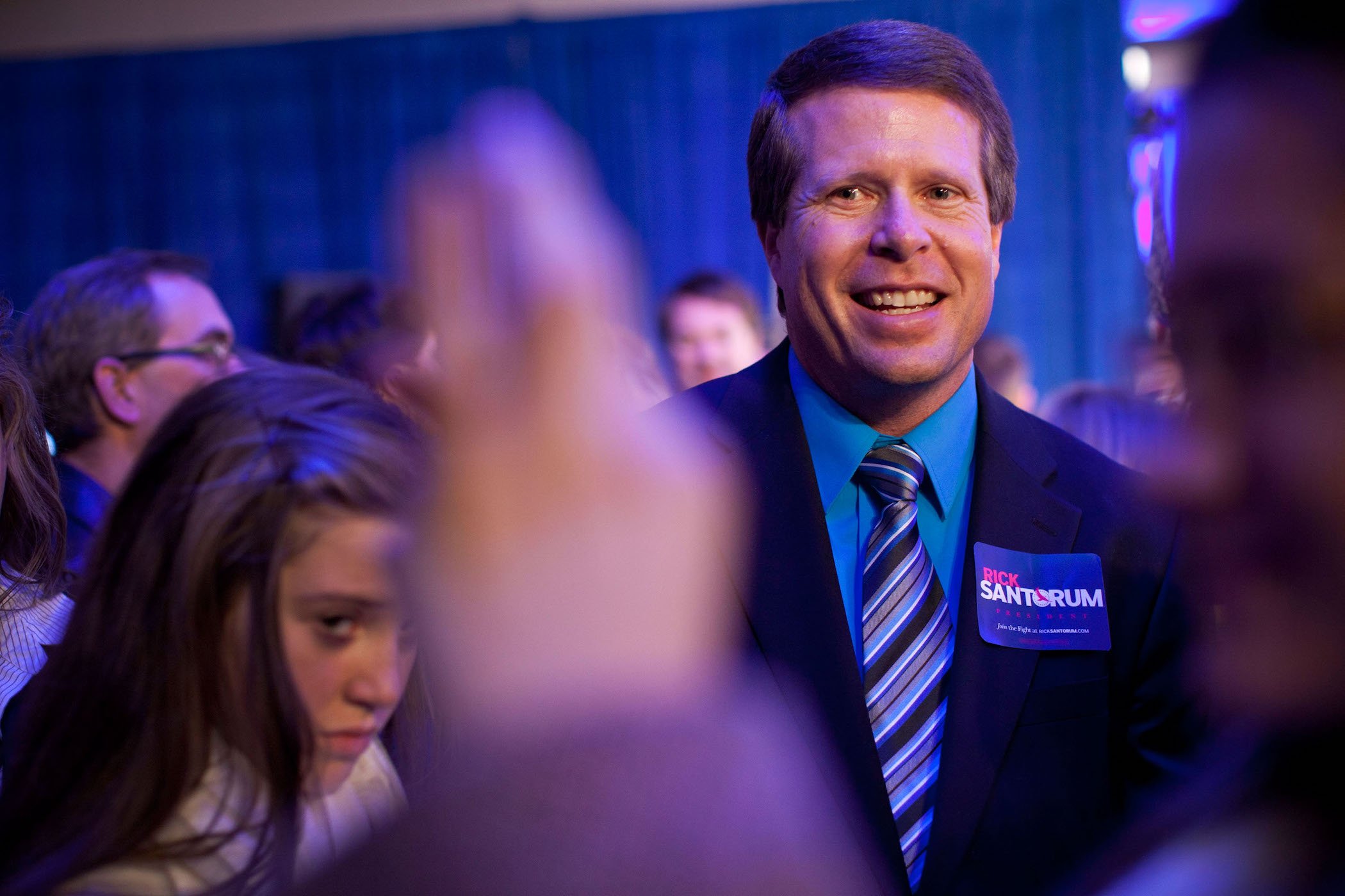 Jim Bob Duggar of the Duggar family smiling at a political event. Jim Bob continues to be in the latest Duggar news as Josh Duggar's trial looms closer.