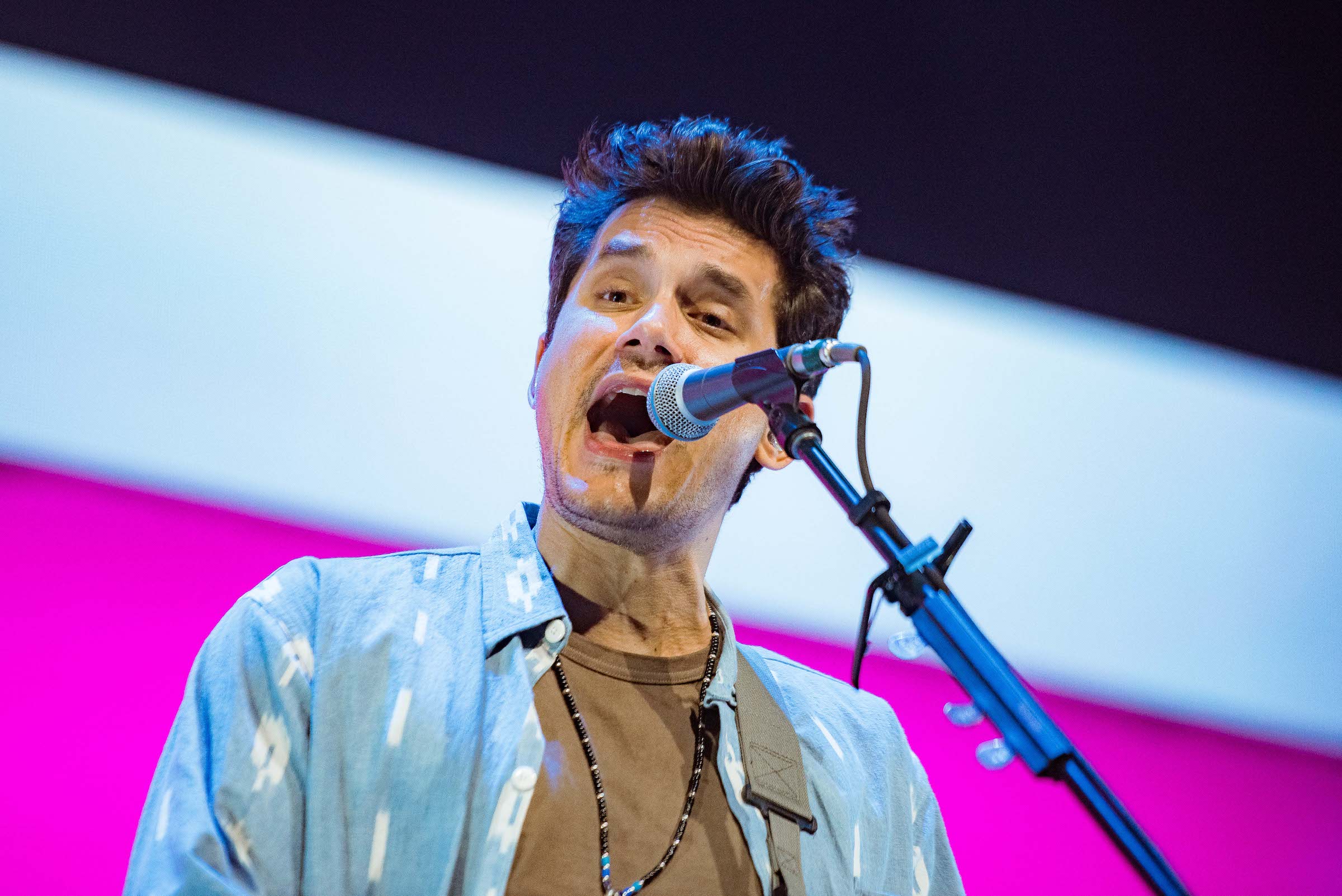 John Mayer singing into a mic