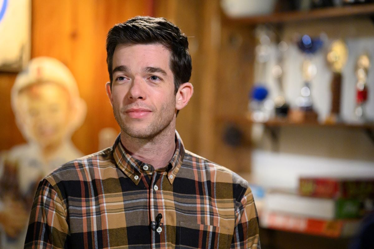 John Mulaney in a plaid shirt