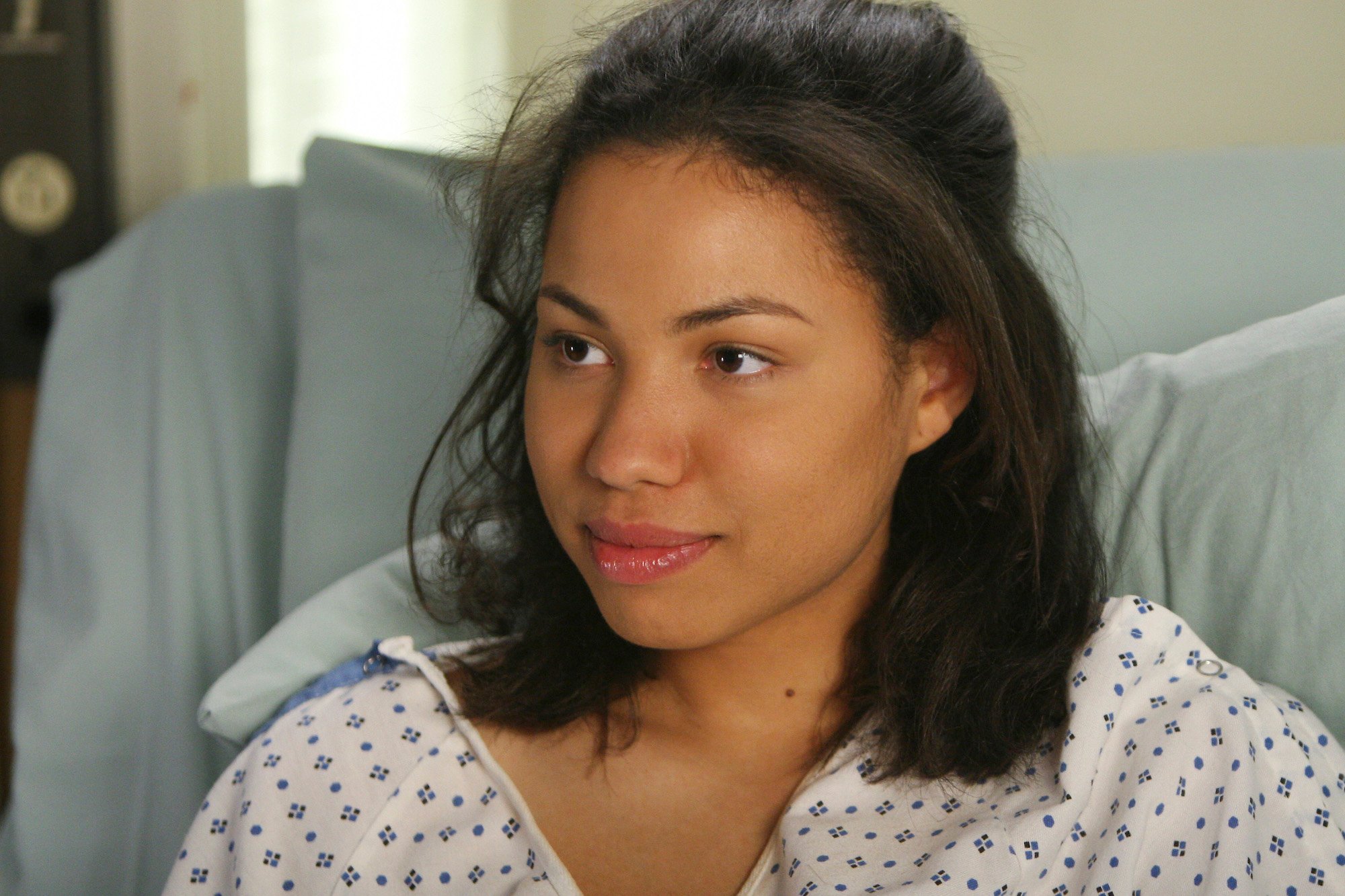 Jurnee Smollett laying in a hospital bed in ABC's 'Grey's Anatomy.'