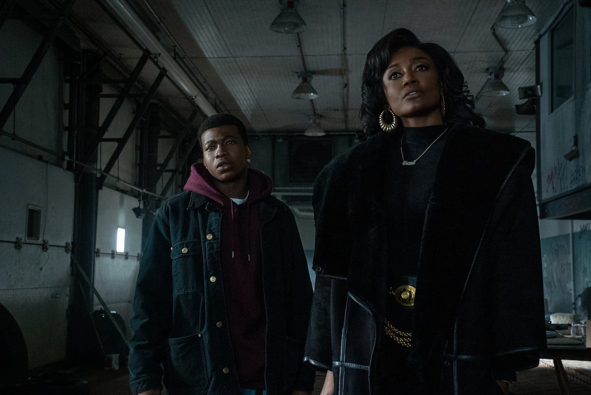 Mekai Curtis as Kanan Stark and Patina Miller as Raquel ‘Raq’ Thomas wearing black coats and standing in a warehouse ‘Power Book III: Raising Kanan’