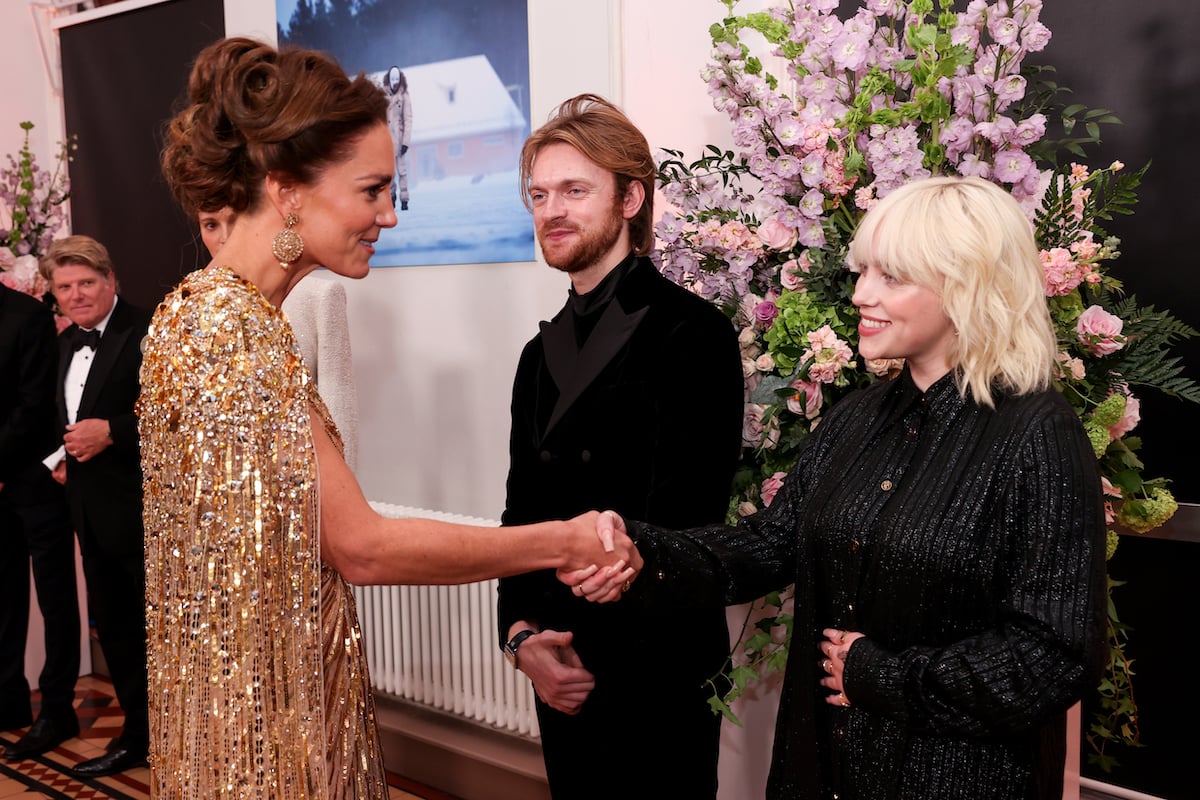 Kate Middleton and Billie Eilish shake hands at an event.