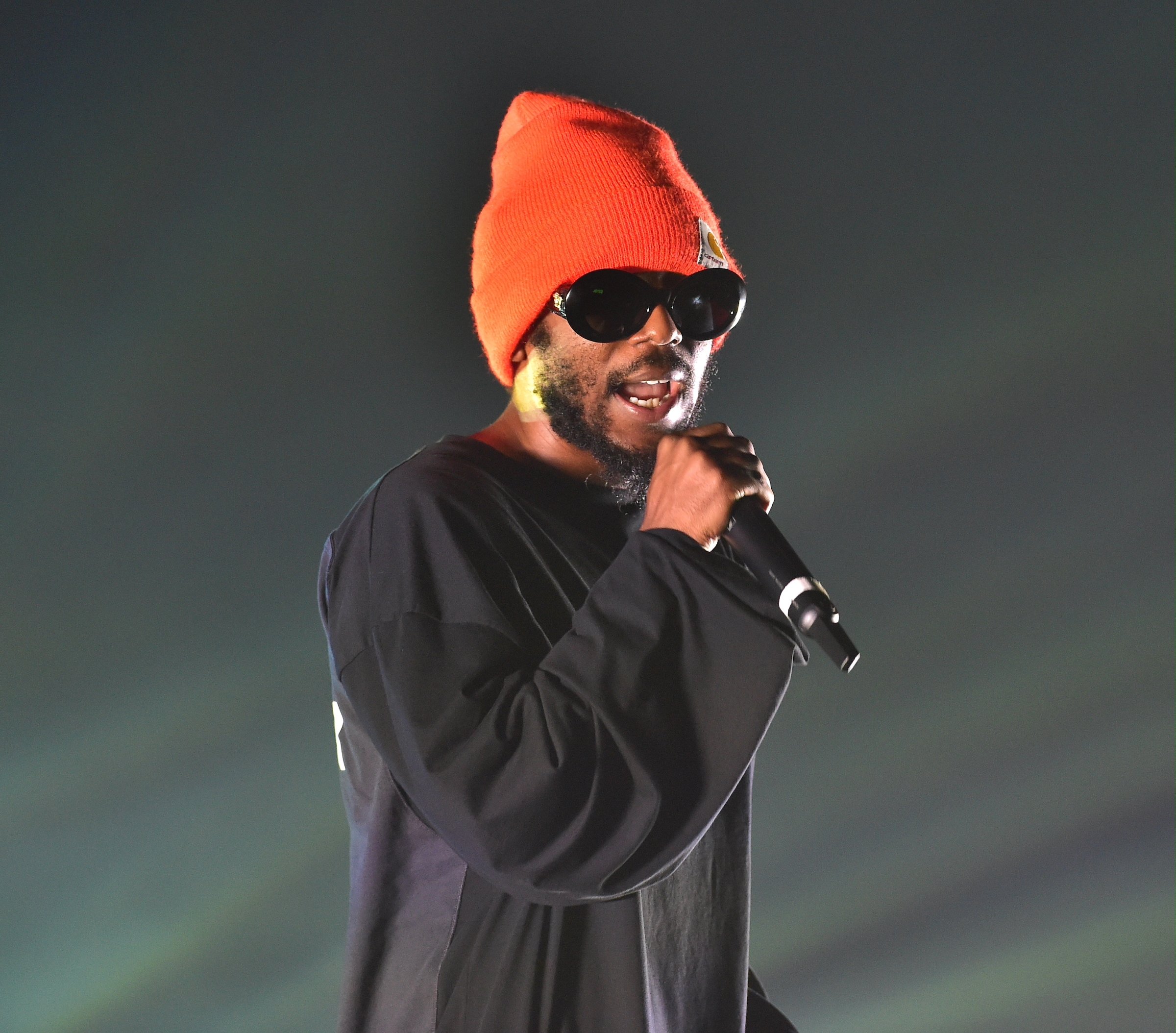 Kendrick Lamar wearing an orange beanie