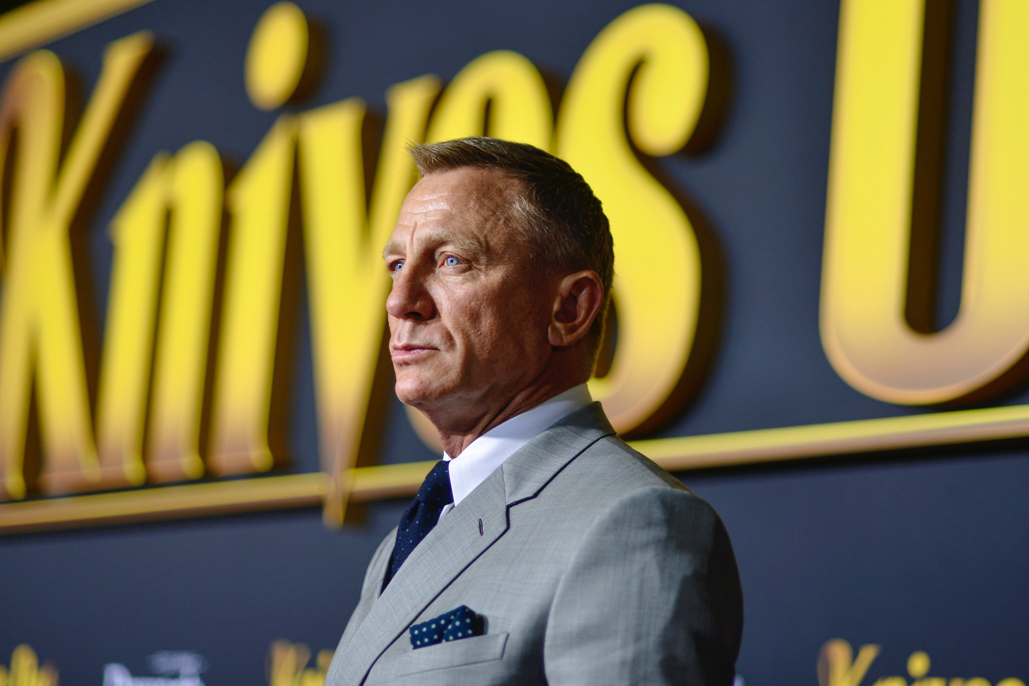 'Knives Out 2' star Daniel Craig wearing a grey suit at the 'Knives Out' premiere at Regency Village Theatre
