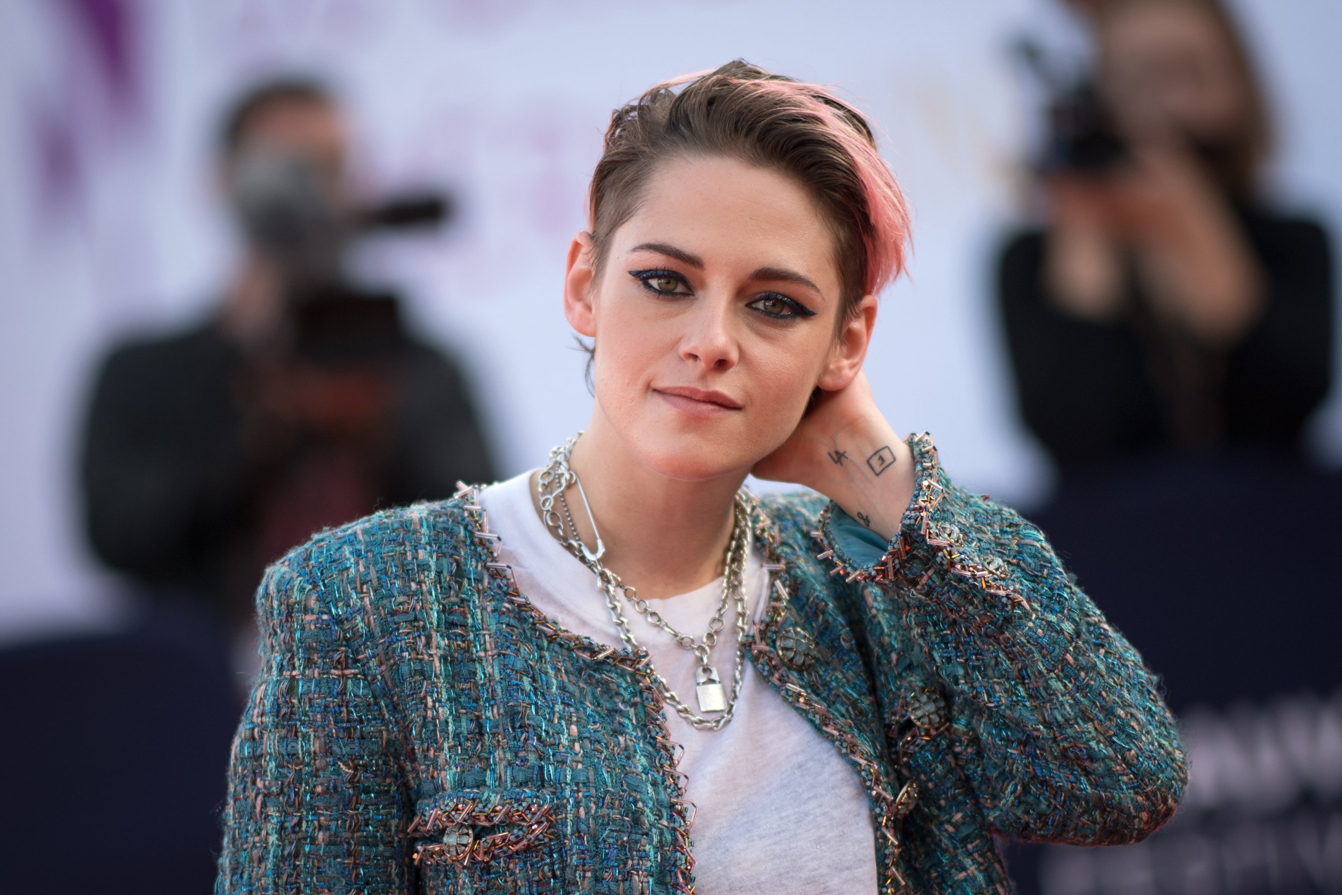 Kristen Stewart, star of the new Spencer movie as the late Princess Diana, tucks her hair back on the red carpet