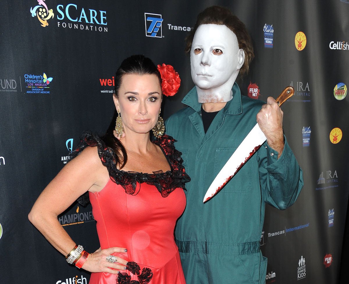 'Halloween Kills' actor Kyle Richards in red dress with Michael Myers