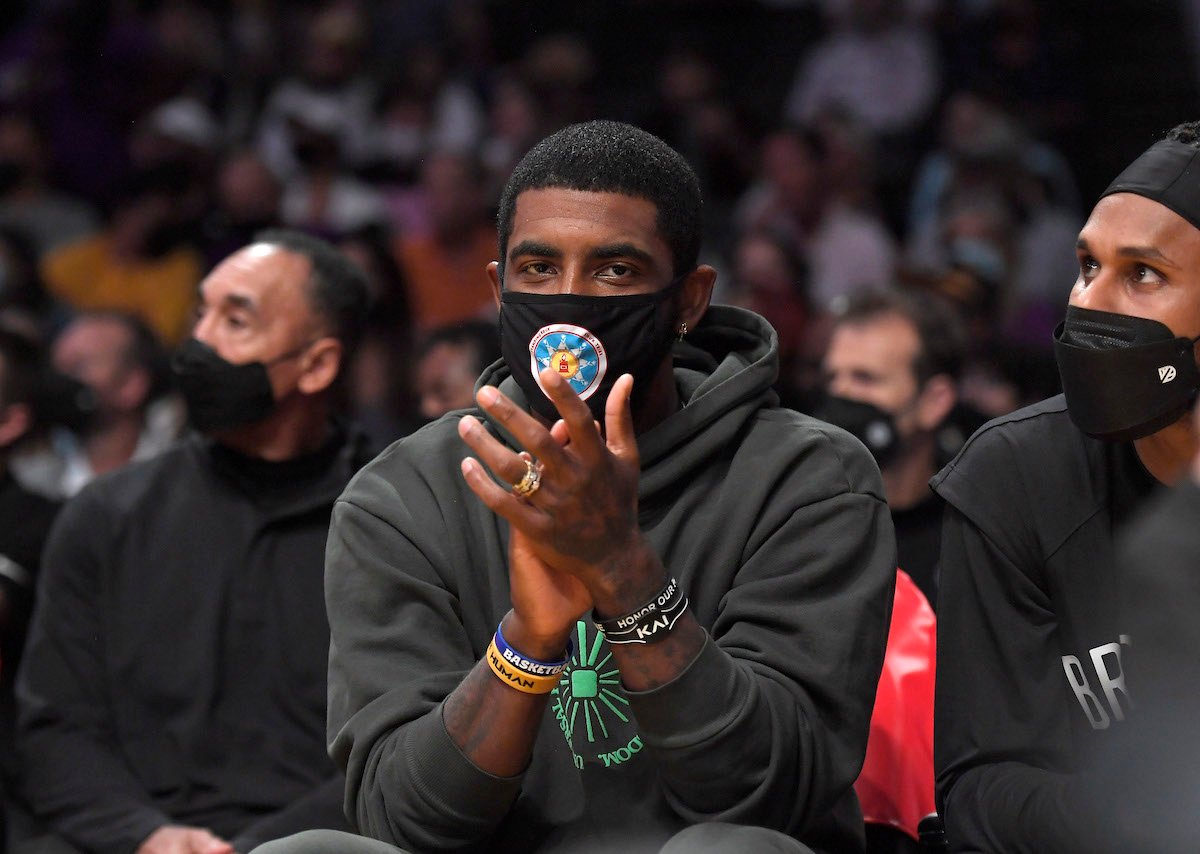 Kyrie Irving of the Brooklyn Nets cheers from the bench