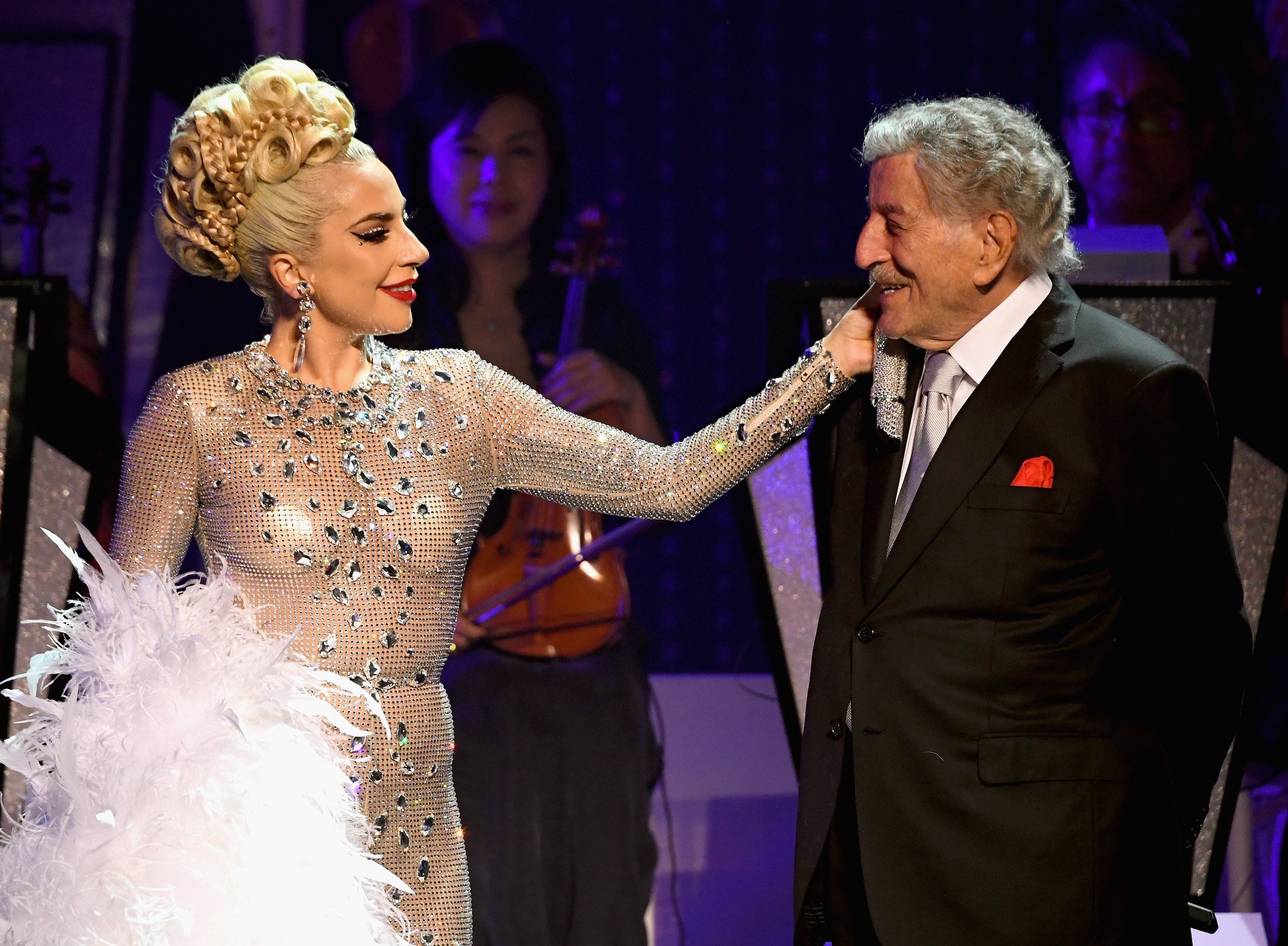 Lady Gaga touching Tony Bennett on stage
