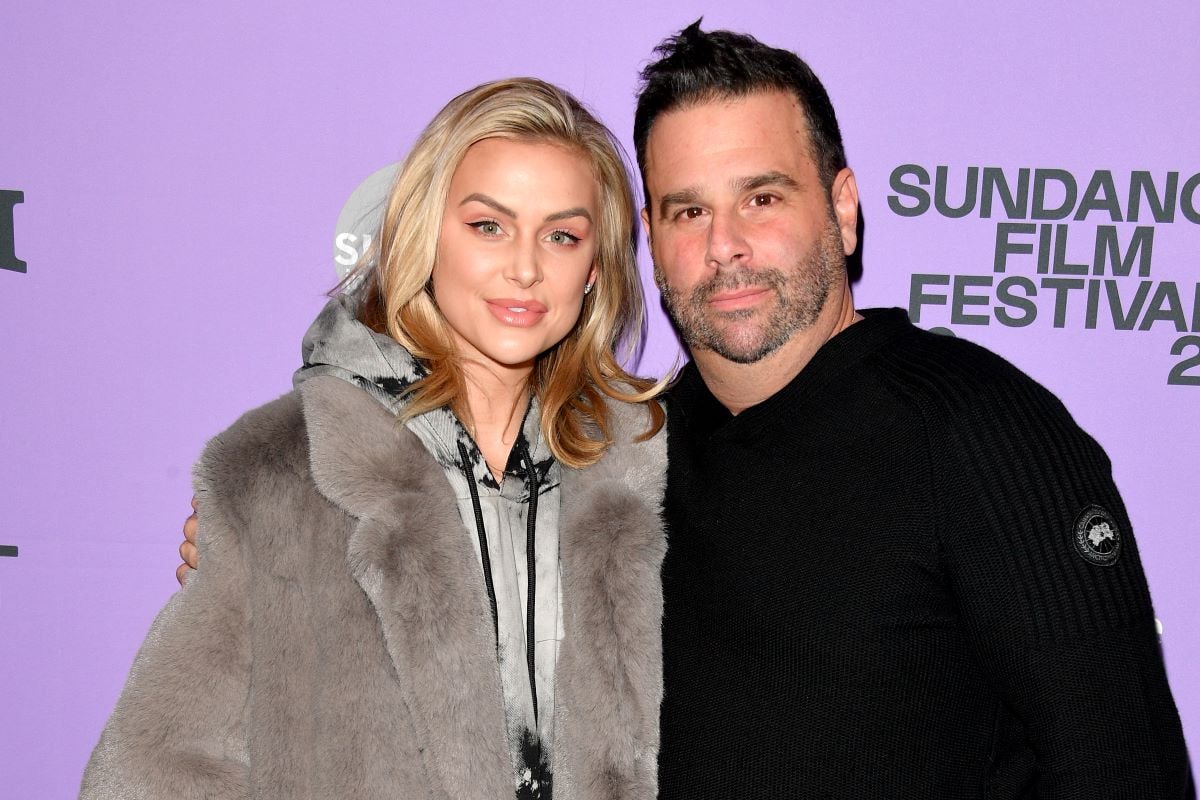 Lala Kent in a fuzzy jacket and Randall Emmett in a black shirt, posing close together