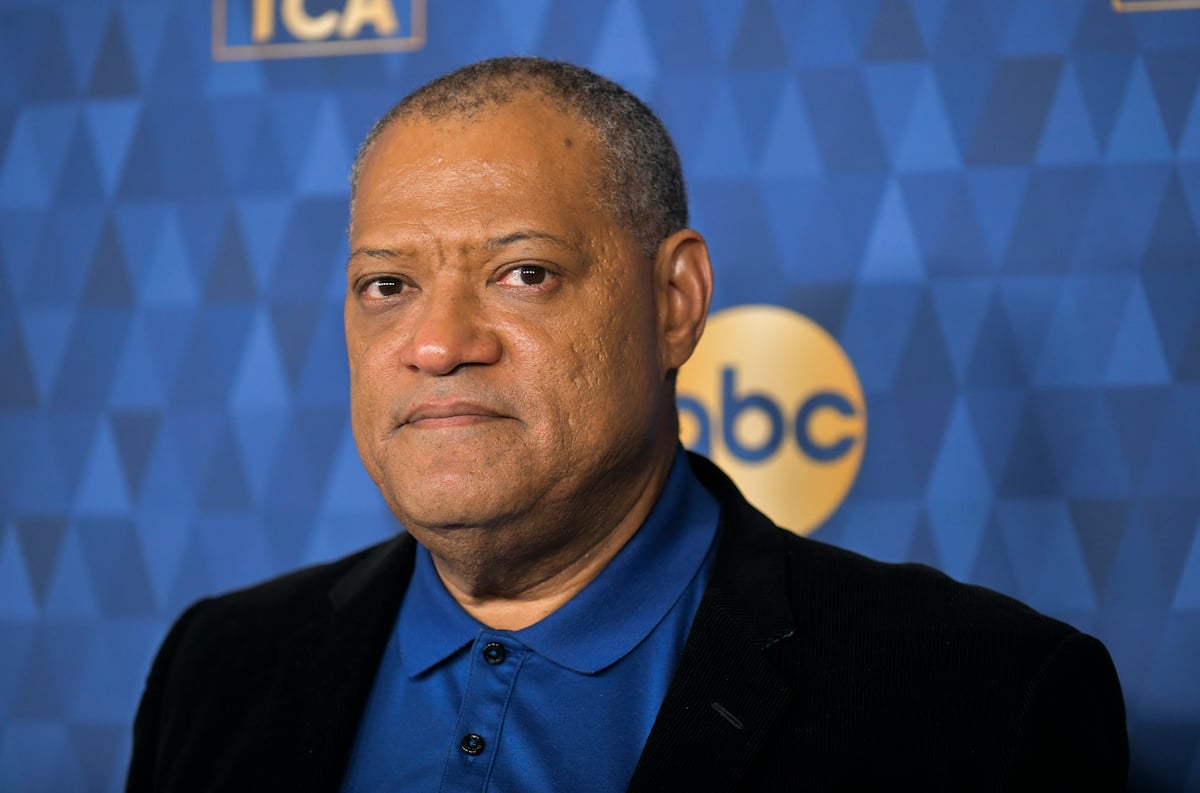 Laurence Fishburne looking at the camera in front of a blue background