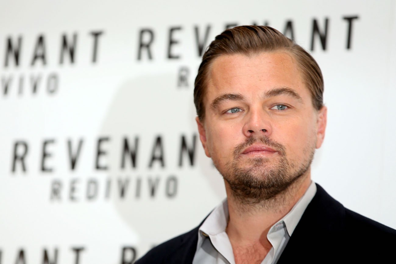 Leonardo DiCaprio at a photo call for 'The Revenant' in 2016 posing for photographers wearing a collared shirt and jacket