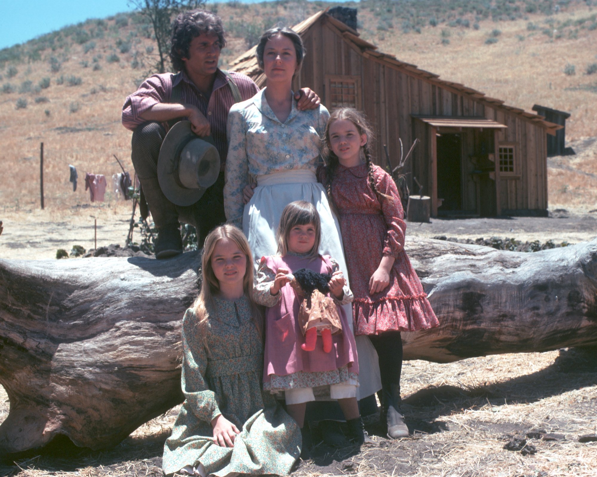 Little House on the Prairie cast poses on a log