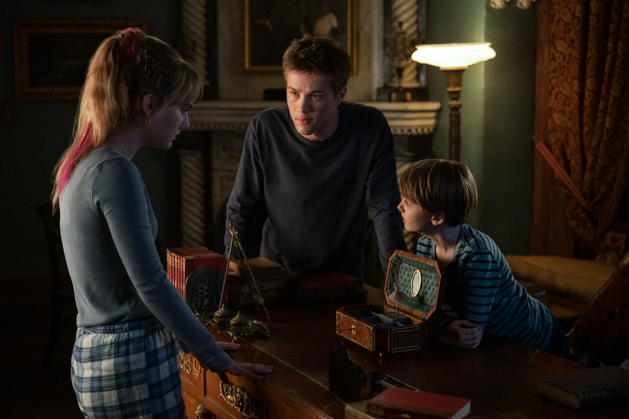 Emilia Jones, Connor Jessup, and Jackson Robert Scott in 'Locke & Key' Season 1. They're huddled over a desk, speaking. All three actors are returning for 'Locke & Key' Season 2 on Netflix, which has a release date of Oct. 22, 2021.