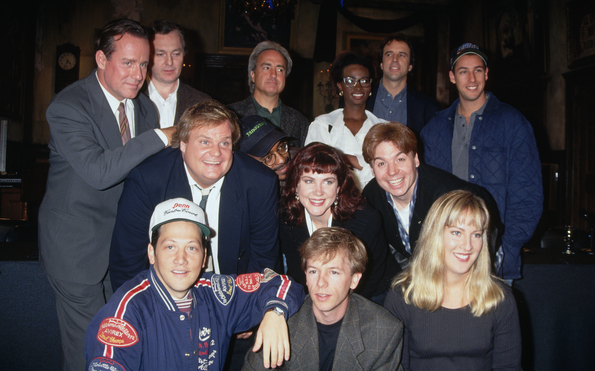 Chris Farley and Lorne Michaels pose with the cast of Saturday Night Live in 1993