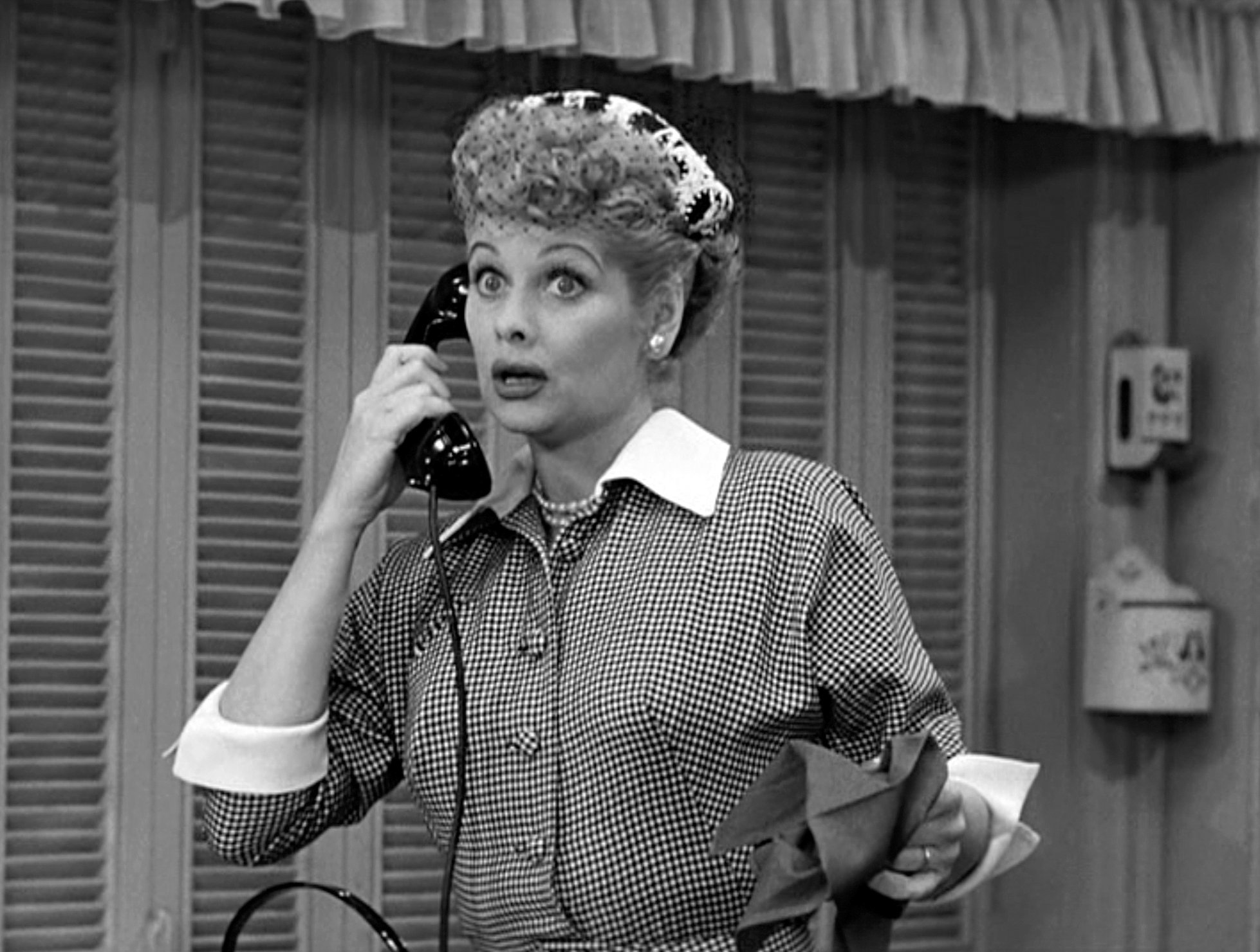 Comedienne Lucille Ball as Lucy Ricardo, talks on the telephone in a scene from an episode of the television comedy 'I Love Lucy' 