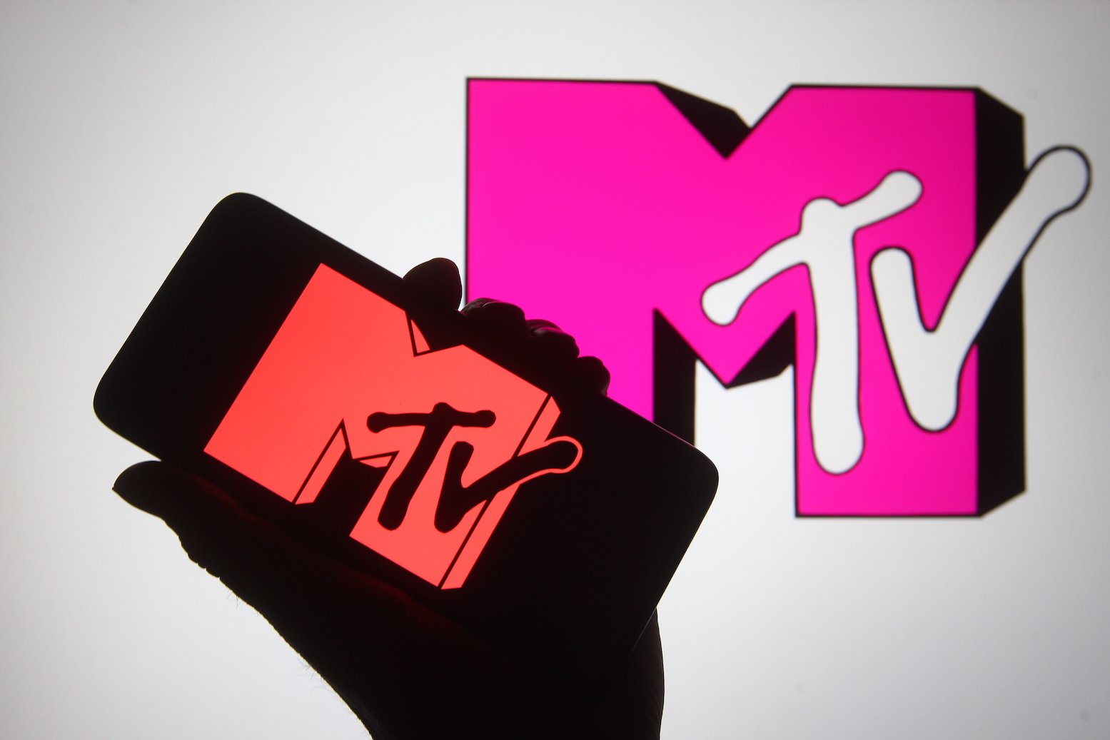 An illustration of a silhouette of a hand holding an MTV symbol. Chris Pearson's death rocked the MTV community in October 2021, and his ex, Haley Read, posted about it to Instagram
