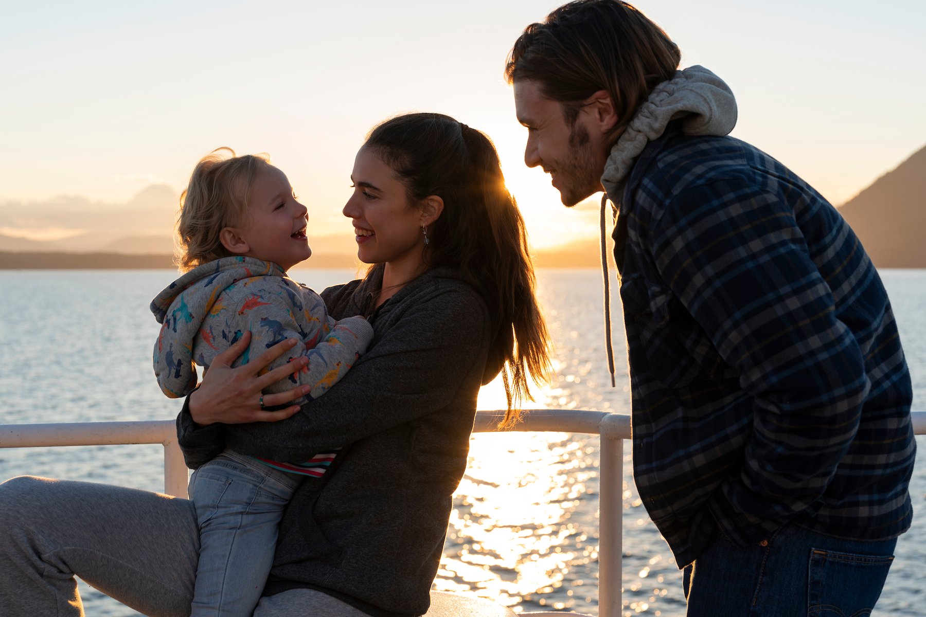 Maddy, Alex, and Sean together on a boat smiling in the Netflix series 'Maid' Season 1. Fans want to know if the cast will return for 'Maid' Season 2