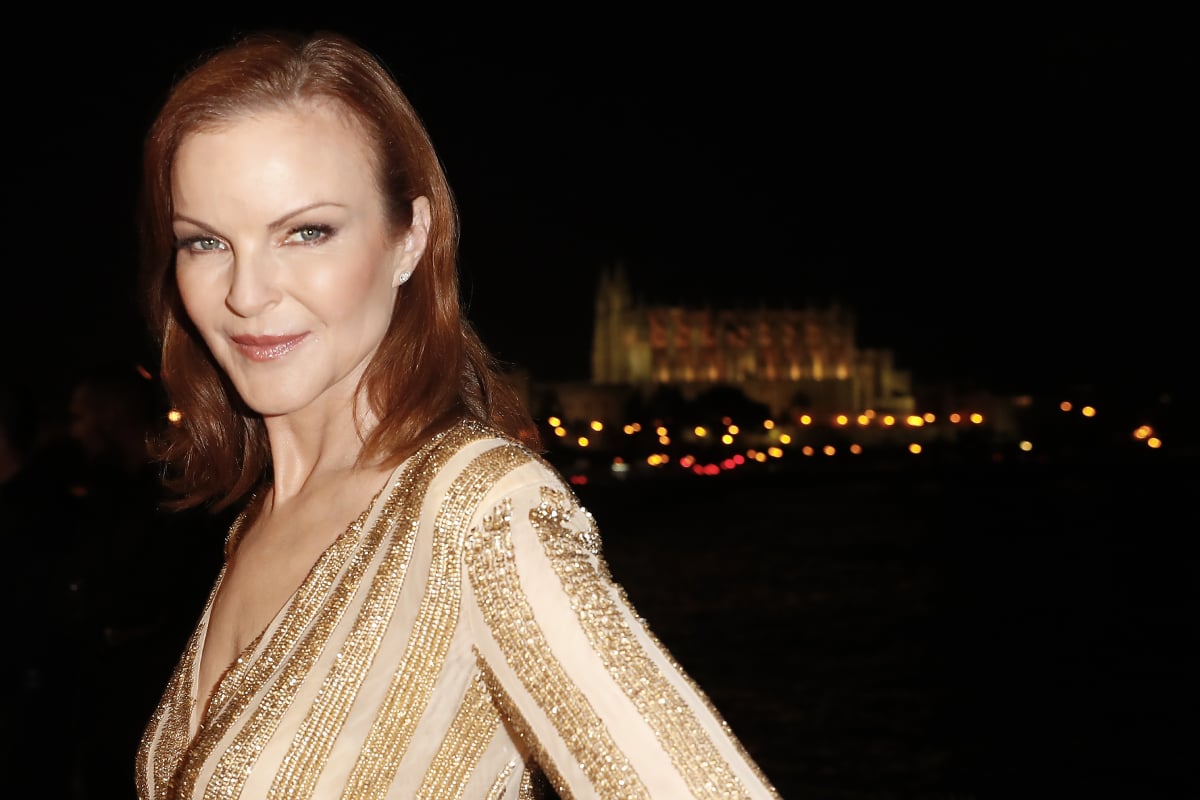 Marcia Cross will appear in 'You' Season 3. In this photo, she smiles and wears a striped top.