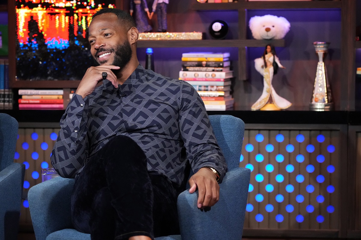 Marlon Wayans smiling in a suit