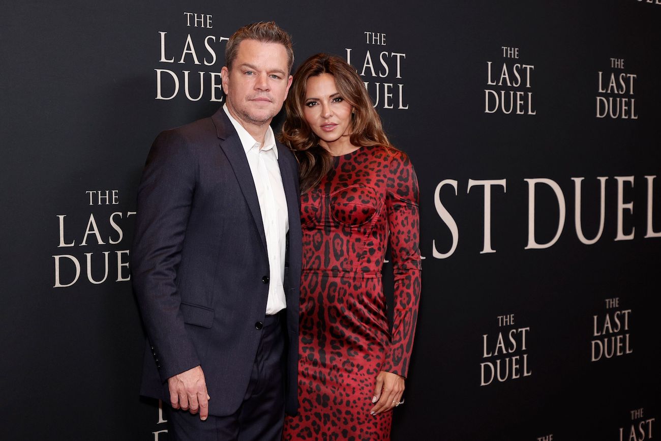 Matt Damon and Luciana Borroso smile as the pose for cameras at the premiere of 'The Last Duel'