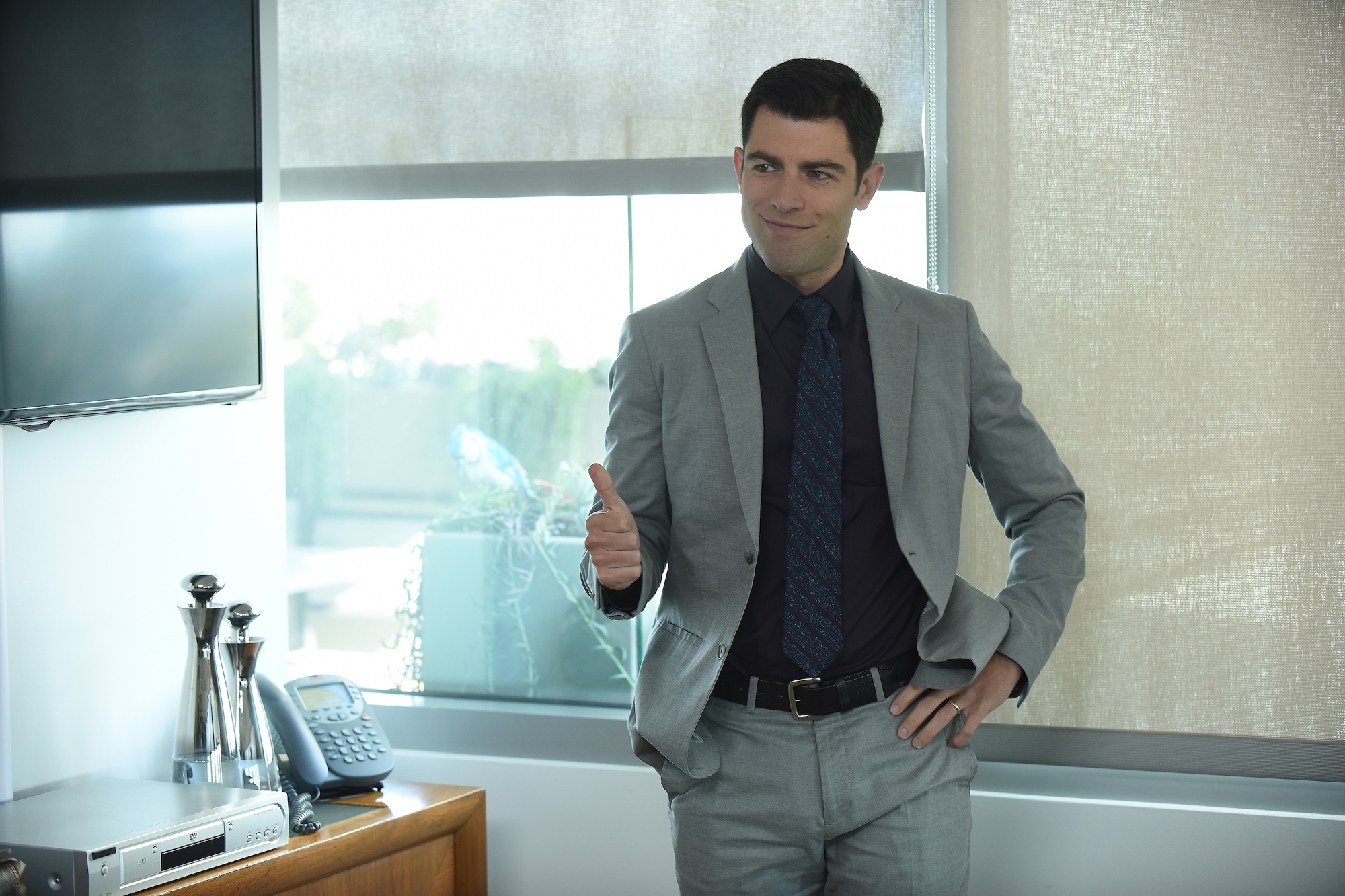 Max Greenfield wearing a gray suit in 'New Girl.'