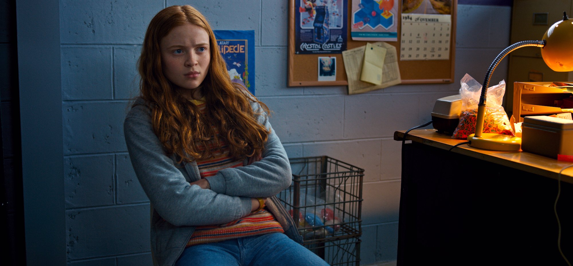 Max Mayfield from 'Stranger Things' is played by Sadie Sink. She's seen here in a sweatshirt jacket, a tshirt, jeans and her signature red hair.