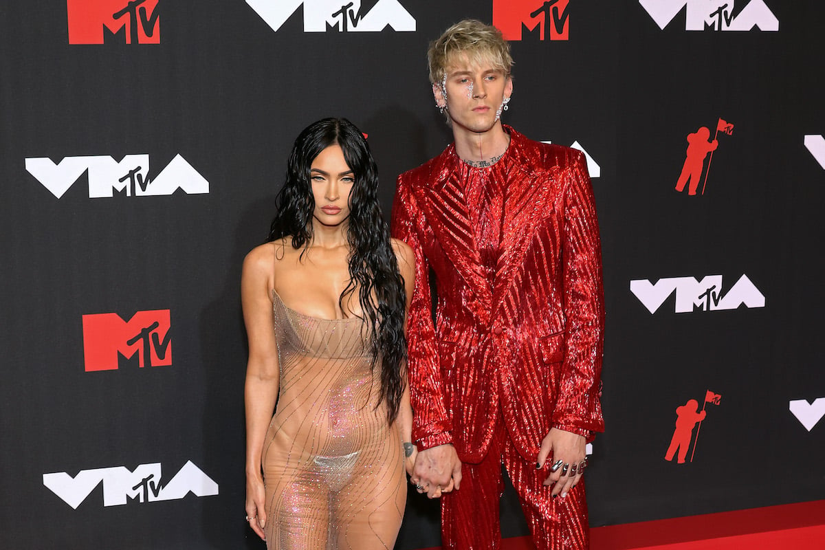 Megan Fox and Machine Gun Kelly pose together at an event.
