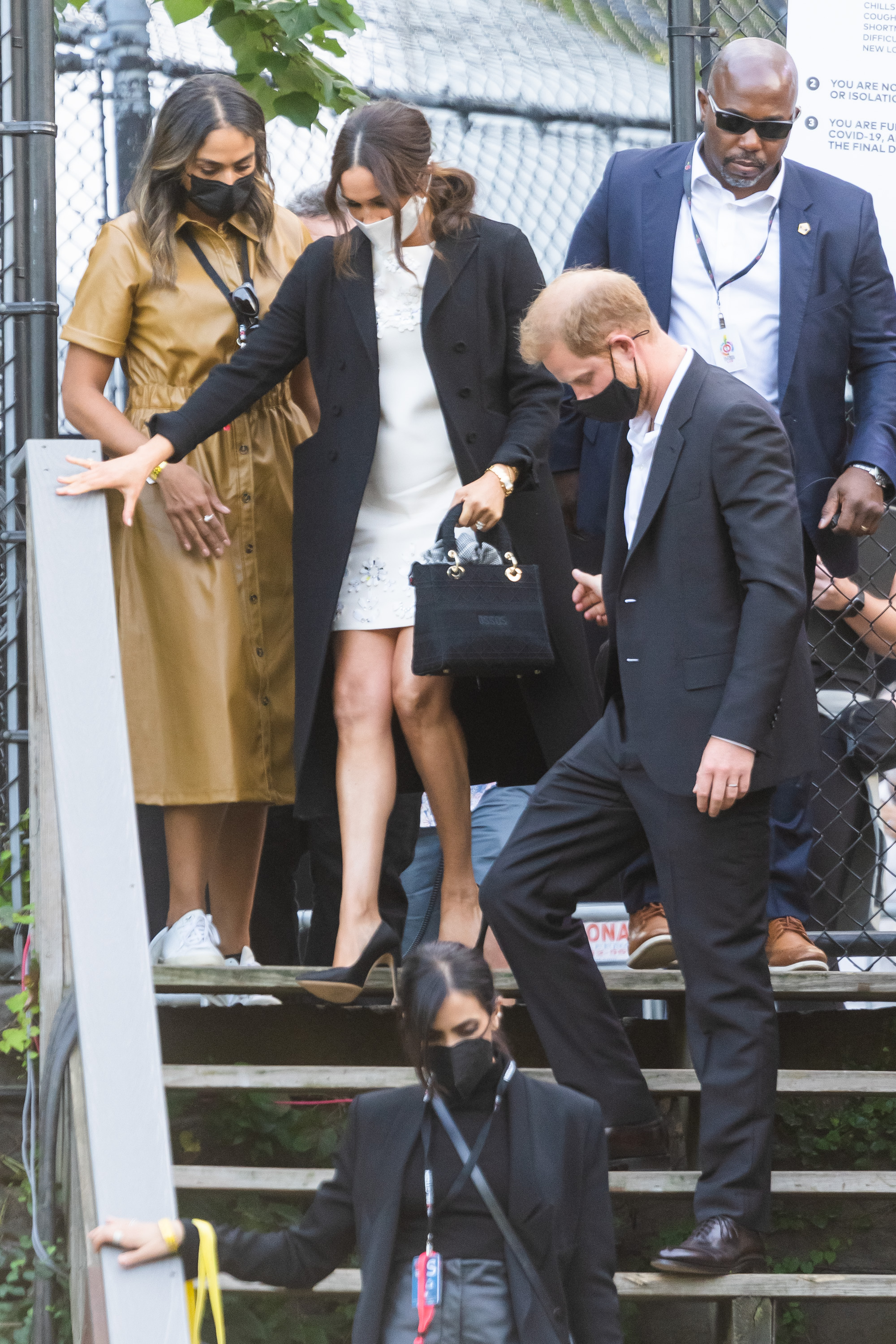Meghan Markle and Prince Harry walking down steps after they depart the Global Citizen concert in Central Park
