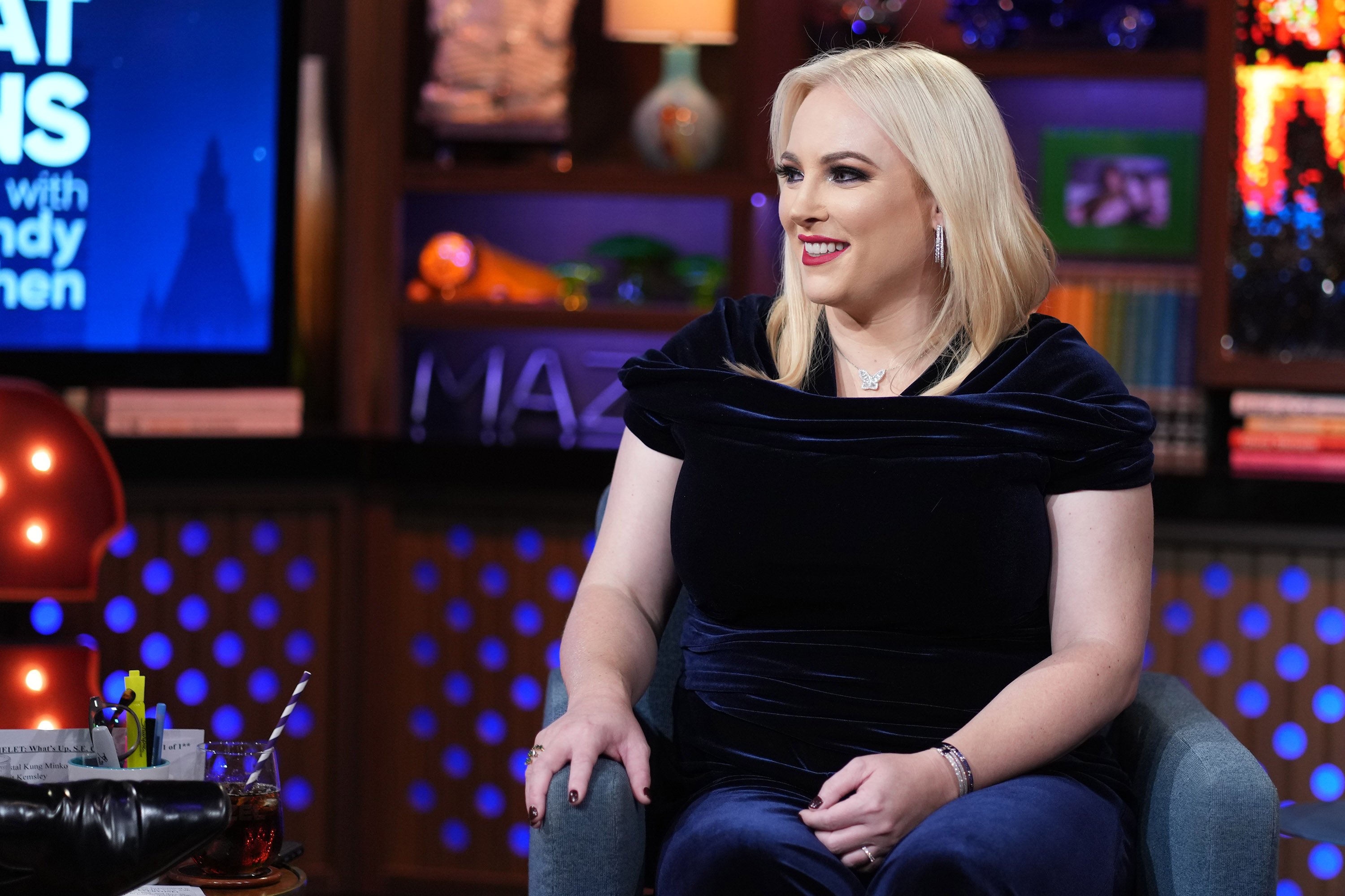 Meghan McCain smiles in a dark shirt on the set of 'Watch What Happens Live with Andy Cohen' 