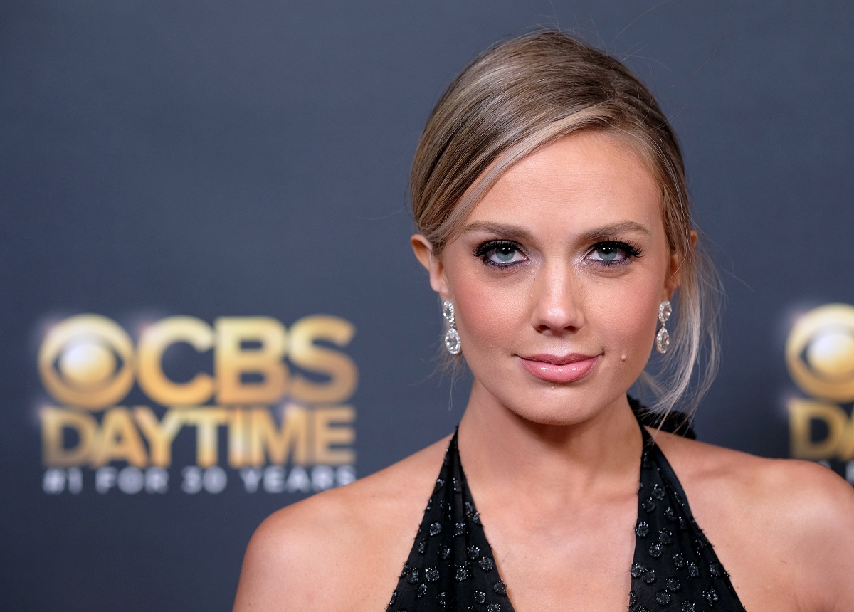 'The Young and the Restless' actor Melissa Ordway in a black dress poses on the red carpet of the Daytime Emmys.