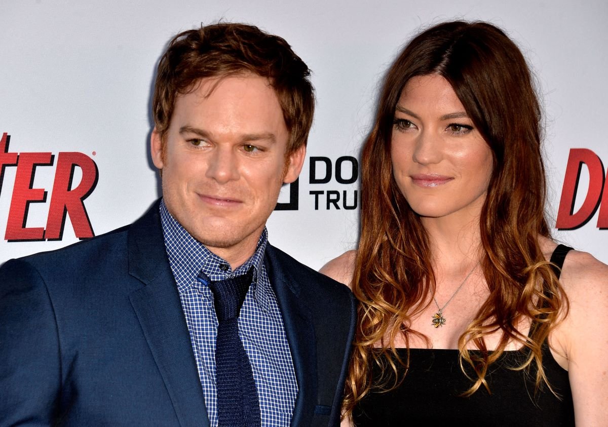 Michael C. Hall in blue suit and Jennifer Carpenter in black, both smiling