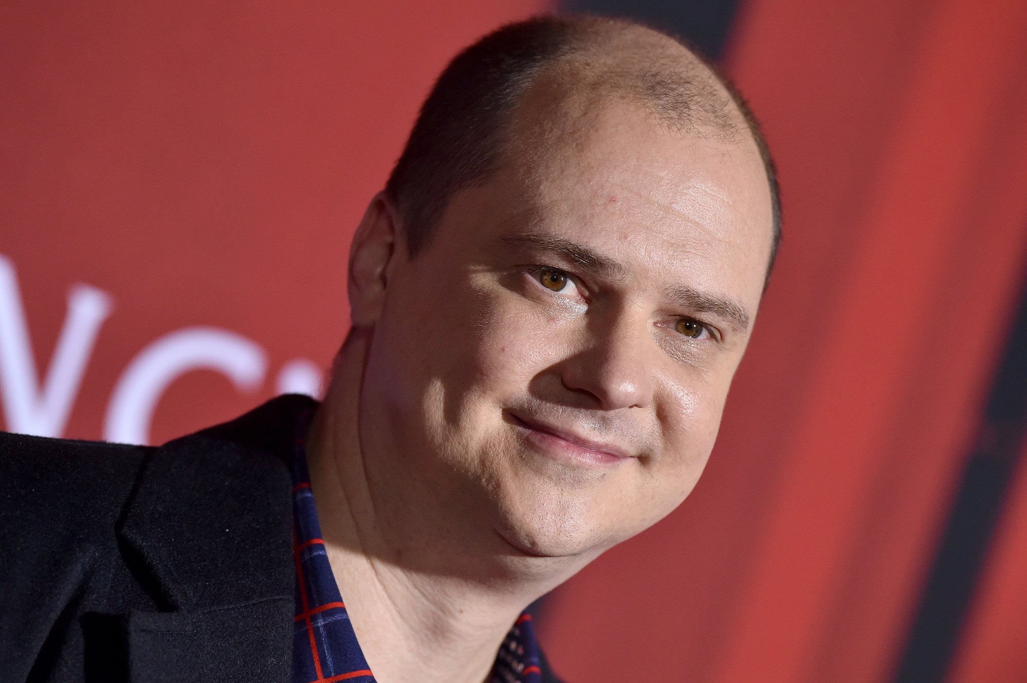 'Midnight Mass' director Mike Flanagan in front of a red backdrop