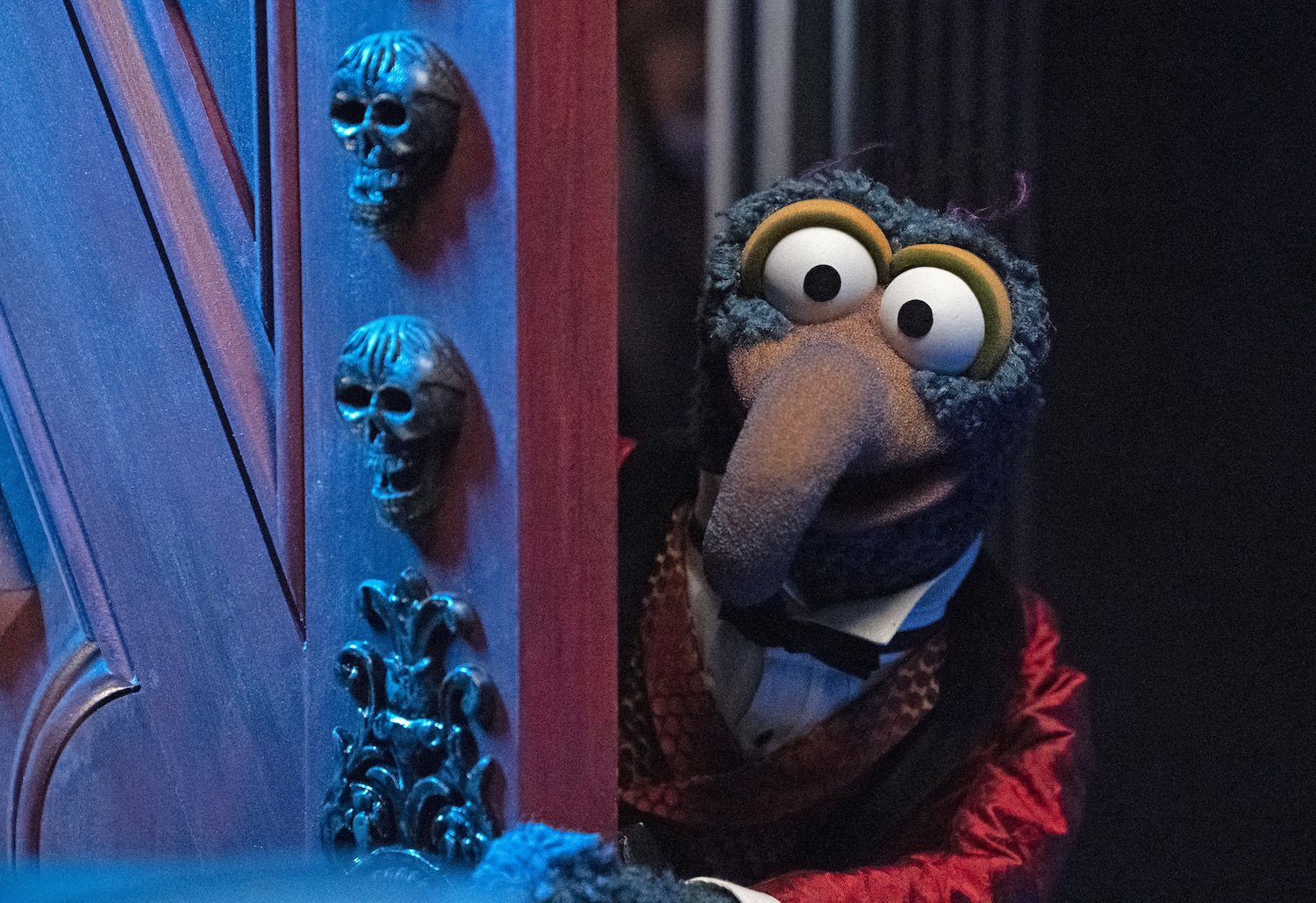 Gonzo peeks around a door in Muppets Haunted Mansion, which is one of Ed Asner's final movies after the Up movie.