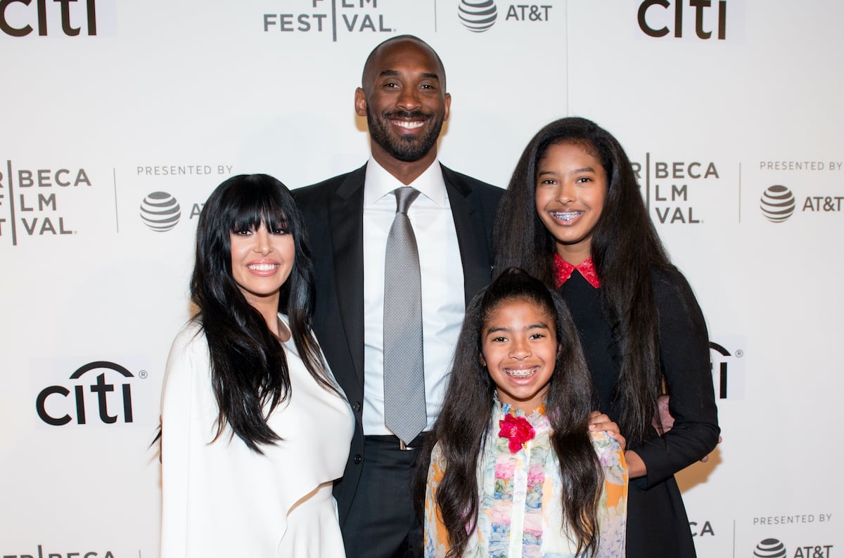 (L-R) Vanessa, Kobe, Gianna, and Natalia Bryant smiling in front of a white background