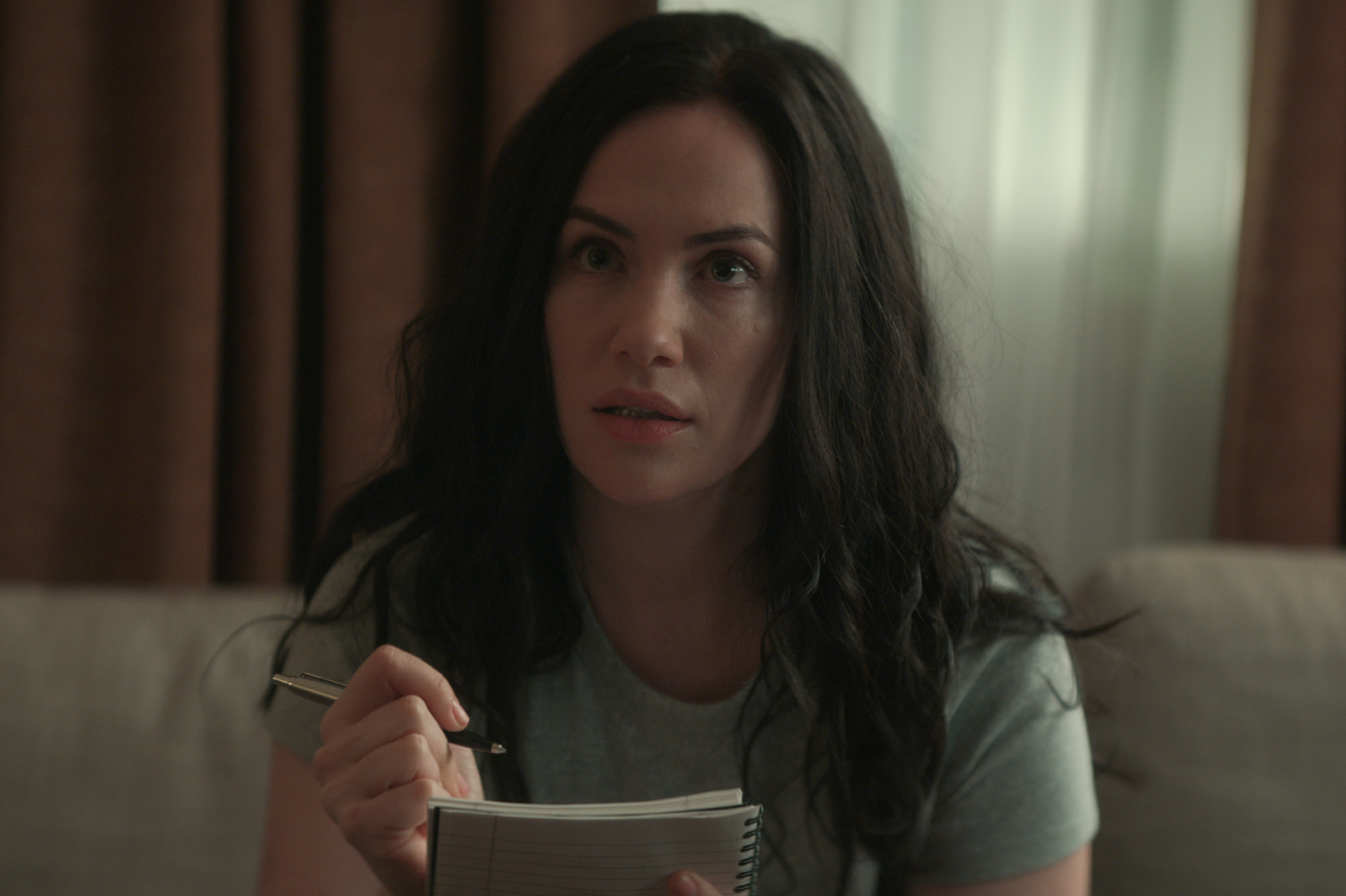 Netflix horror movie 'Hypnotic' actor Kate Siegel holding a pen and notebook