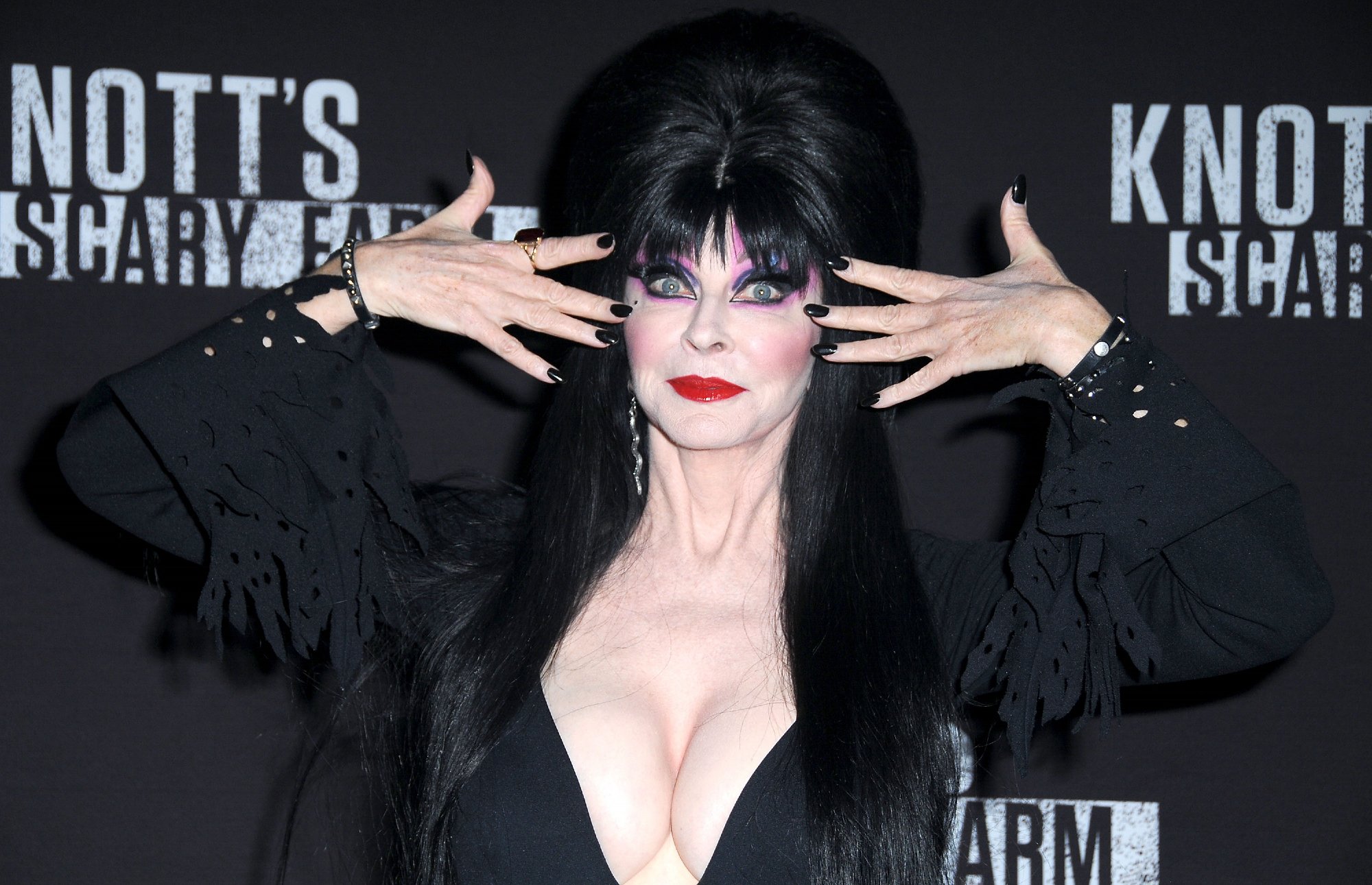 Netflix host Elvira posing wearing black at Knott's Scary Farm and Instagram Celebrity Night at Knott's Berry Farm