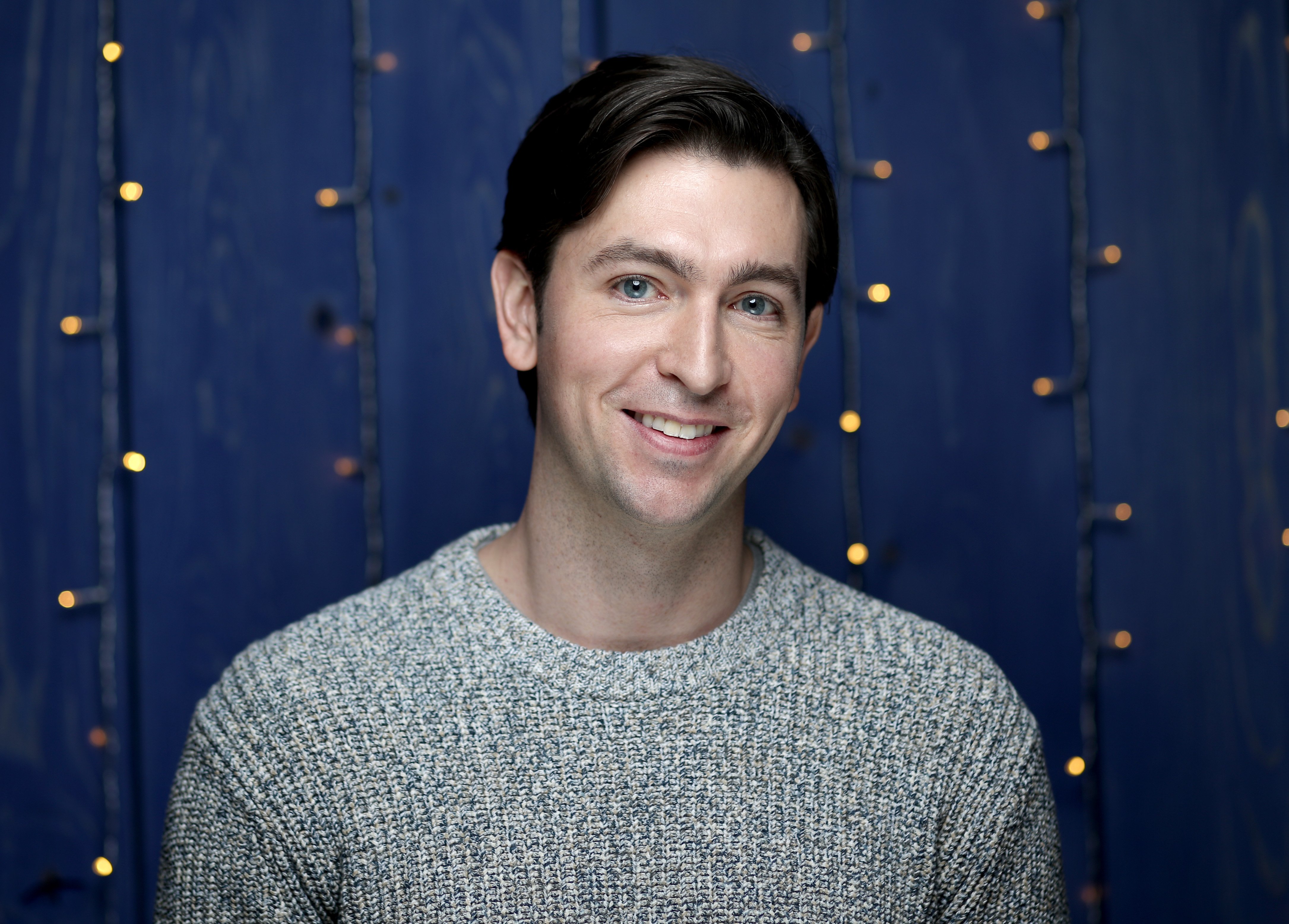 Succession cast member Nicholas Braun in a gray sweater.