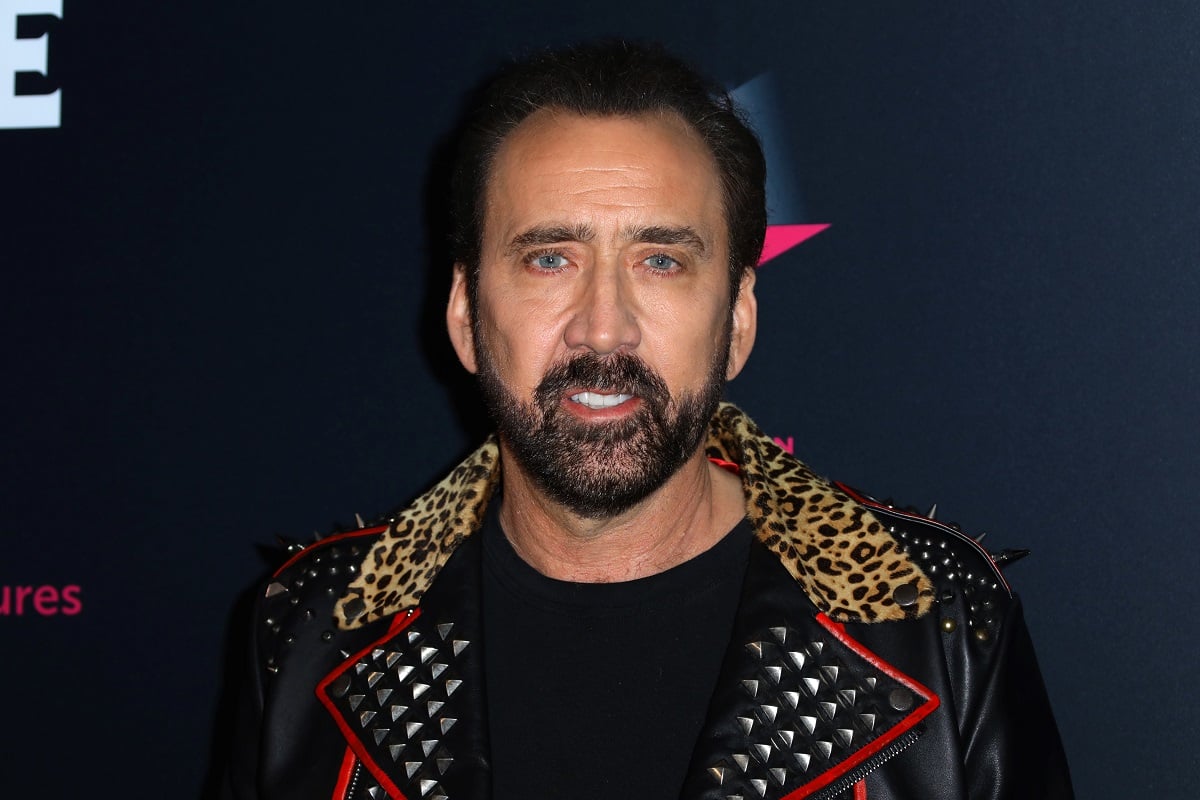Nicolas Cage posing wearing a suit