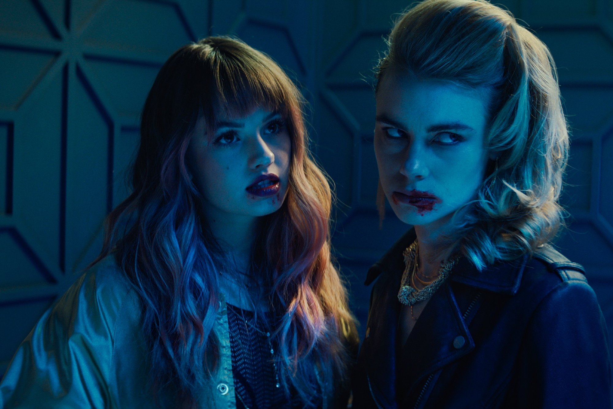 'Night Teeth' stars Debby Ryan as Blaire and Lucy Fry as Zoe with blood on their mouths
