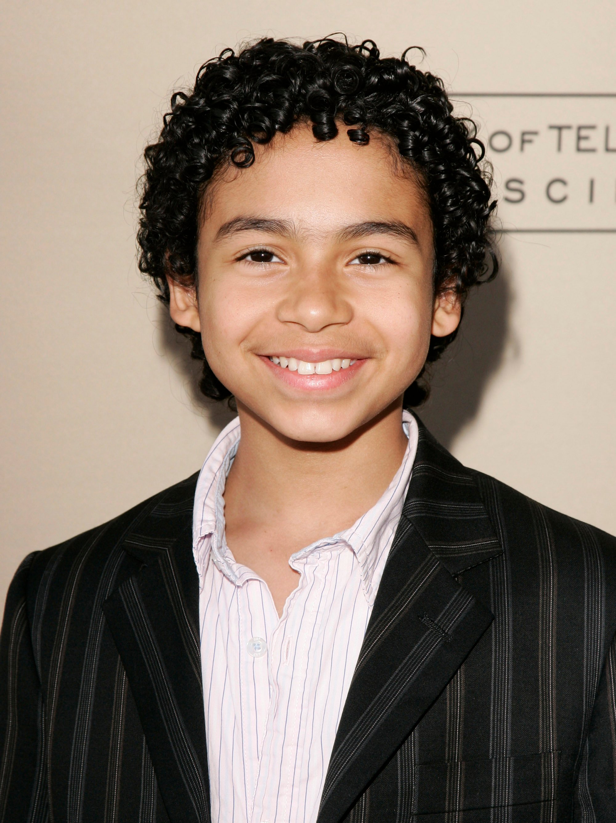 Noah Gray-Cabey wearing a black suit jacket to the 'Heroes' red carpet event.