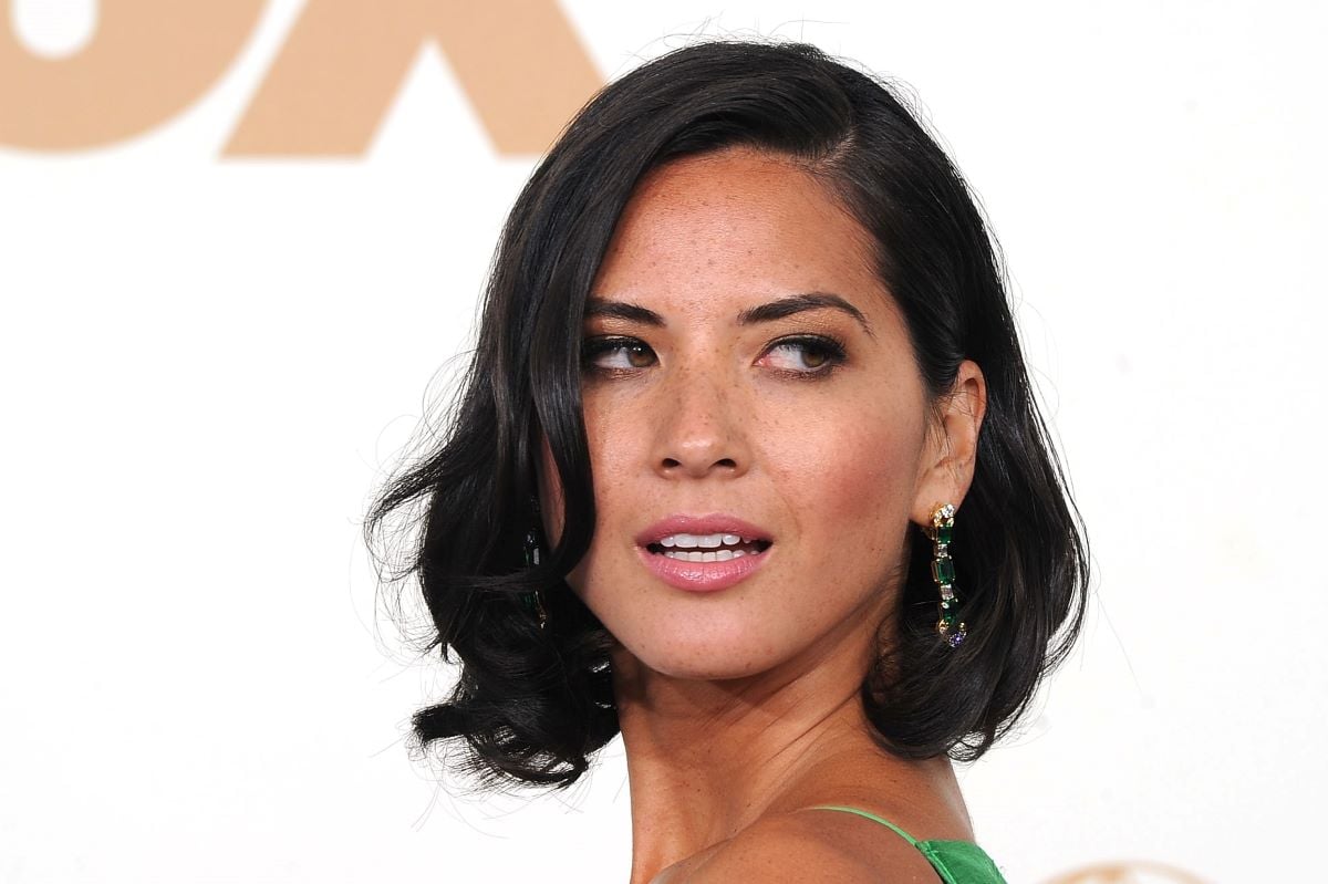 Olivia Munn with short hair looking over her shoulder